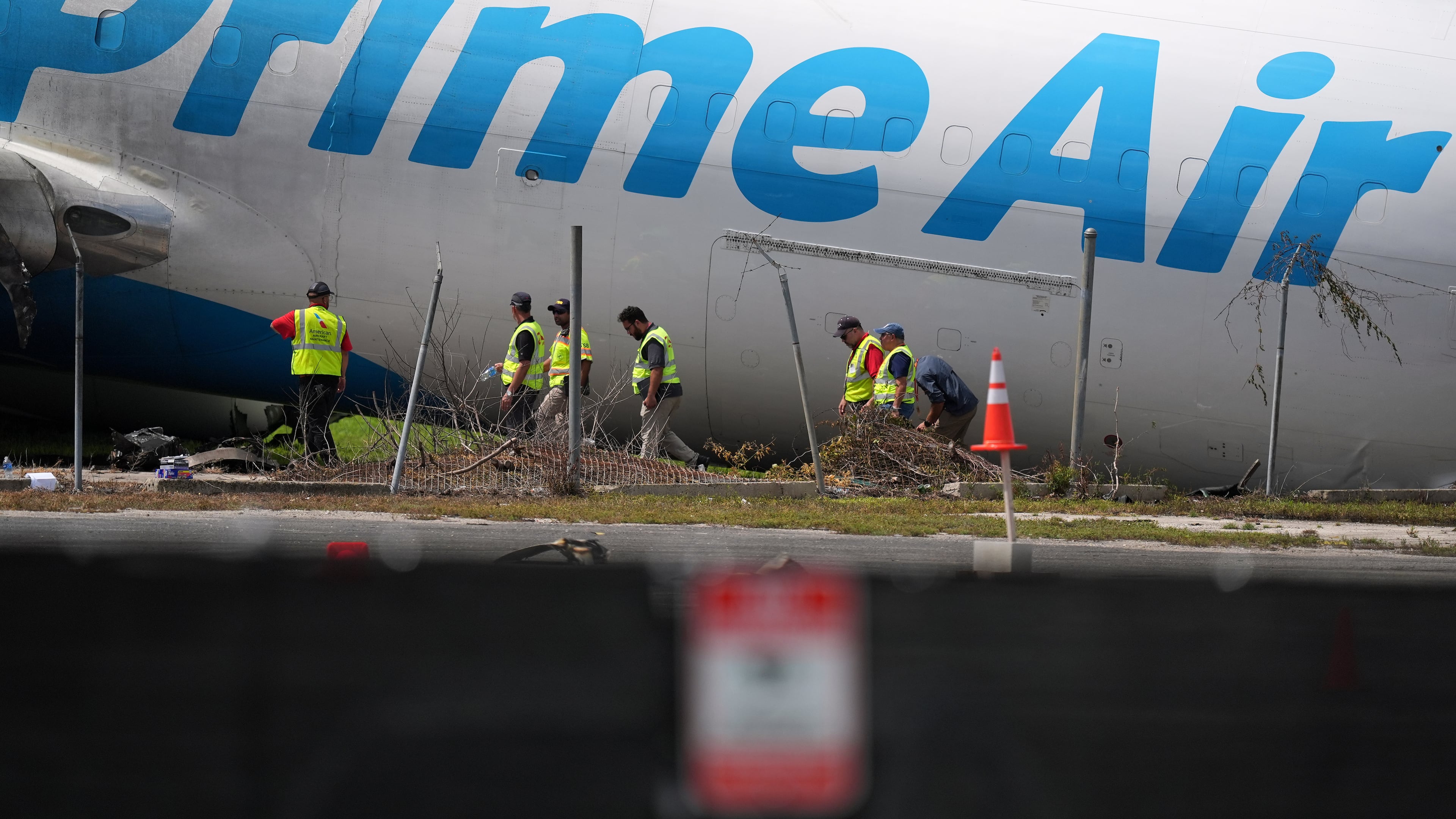 Workers inspect an Amazon cargo plane two days after it overshot a runway at Miami International Airport, Tuesday, Sept. 8, 2026, in Miami. (AP Photo/Rebecca Blackwell)