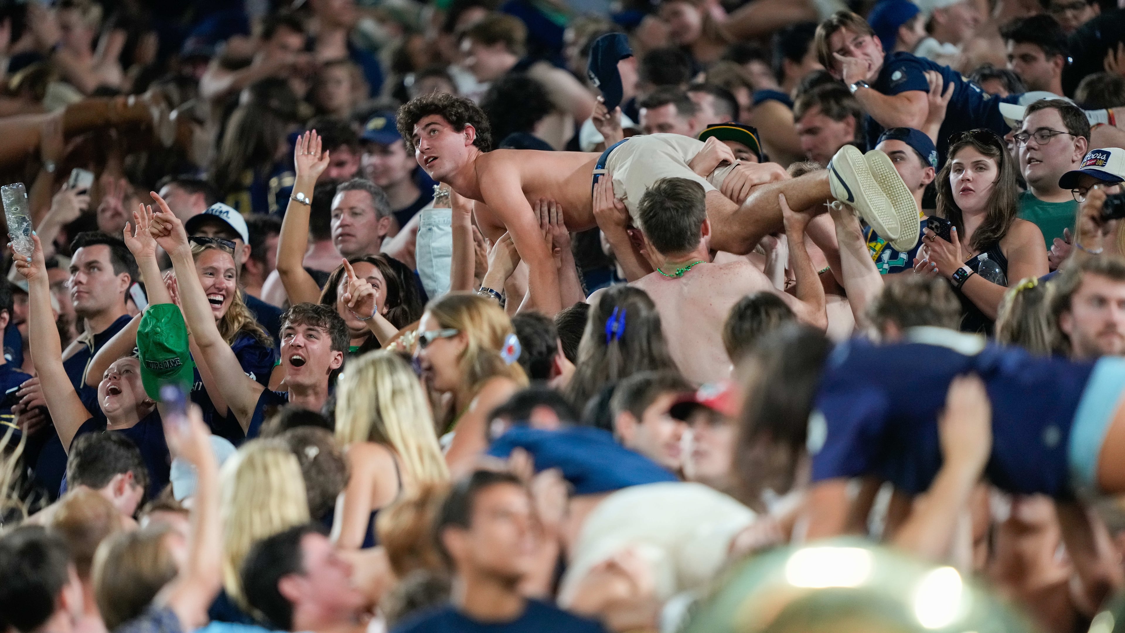 Notre Dame fans celebrate scoring a touchdown with pushups during the second half of an NCAA college football game against Wisconsin Sunday, Sept. 6, 2026, in Green Bay, Wis. (AP Photo/Kayla Wolf)