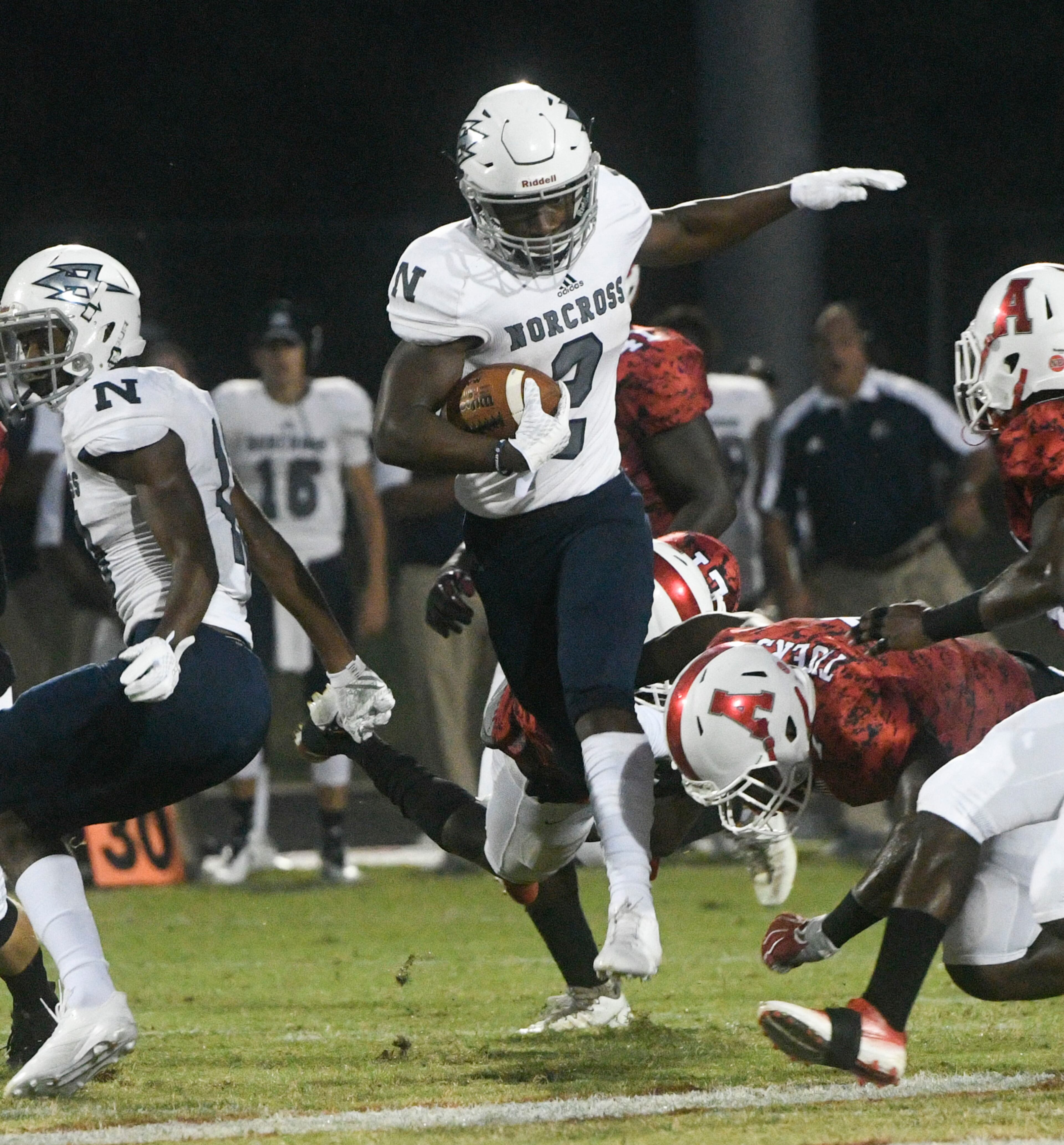 Norcross RB Clay Harris (2) leaps through defenders during a high school football game, Friday, Sept. 15, 2017, in Lawrenceville. (Special/John Amis)