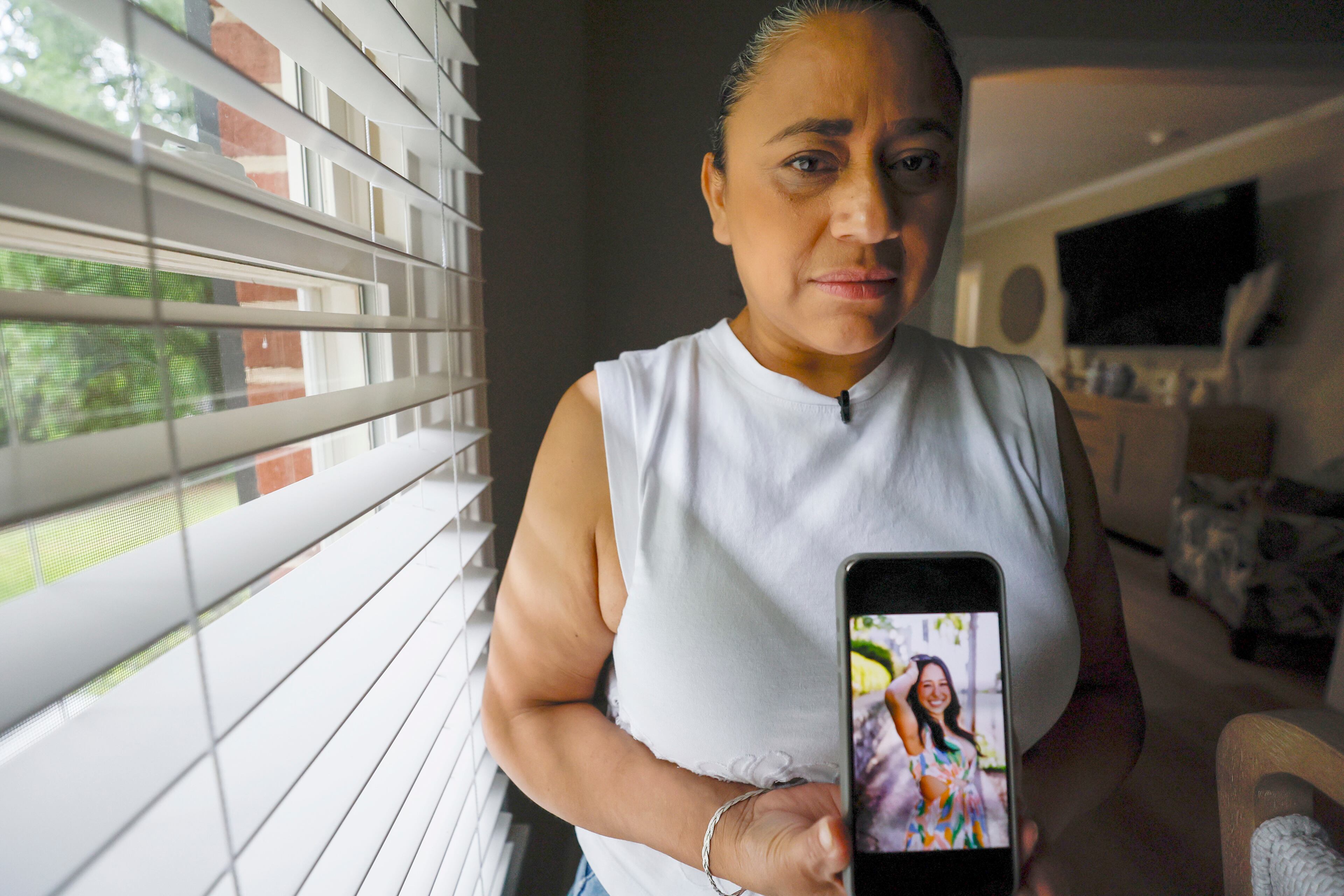 Ndahitha Cristobal displays a photo of her daughter Ximena Arias-Cristobal. The Cristobals are one of many Dalton families plunged into crisis by increased ICE arrests.