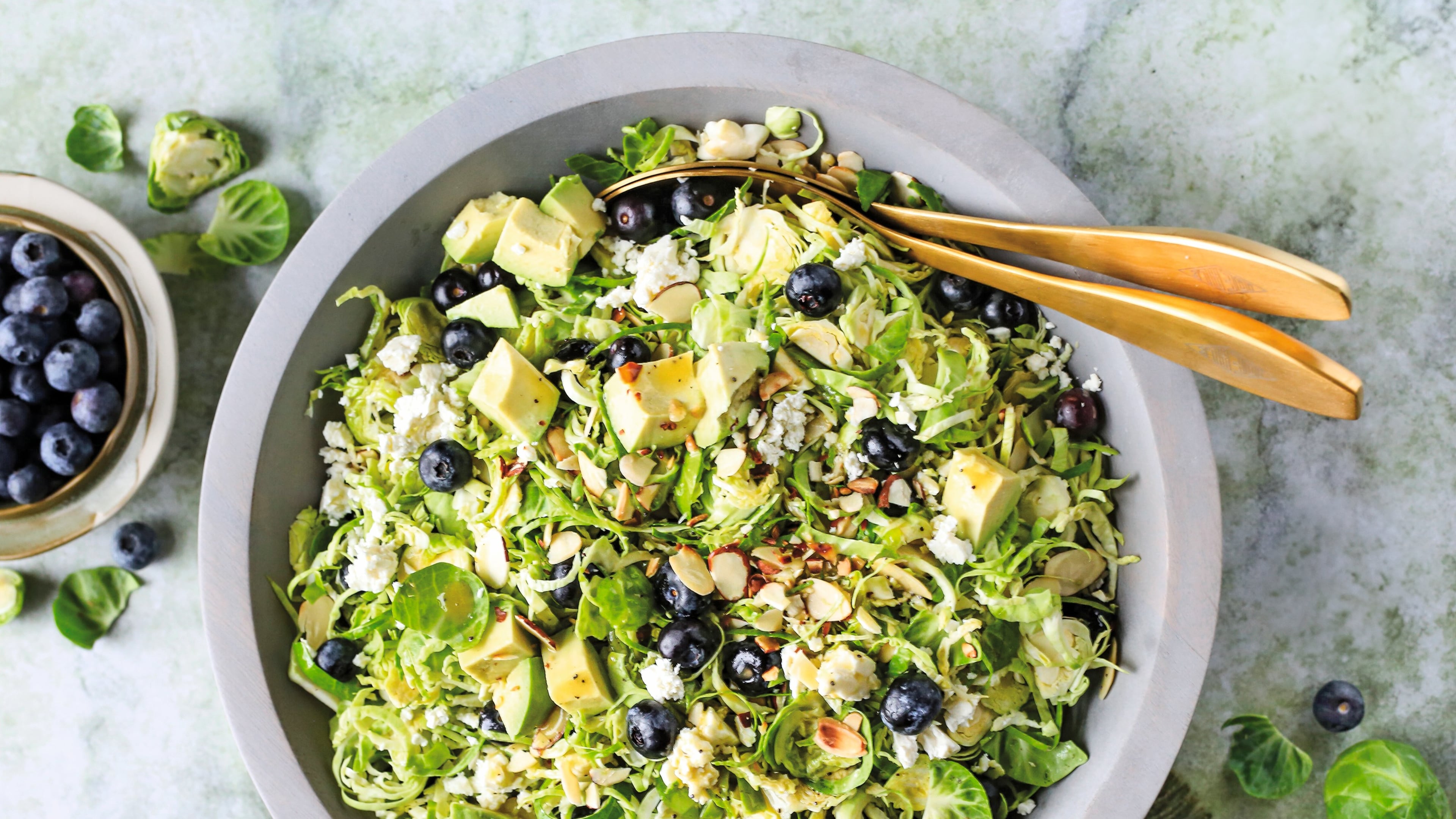 This Brussels sprout salad is dressed in a white balsamic vinaigrette and topped with fresh blueberries, sliced almonds and crumbly feta. (Reprinted with permission from “Every Salad Ever” by Greta Podleski, copyright © 2025. Published by Clarkson Potter, a division of Penguin Random House LLC)