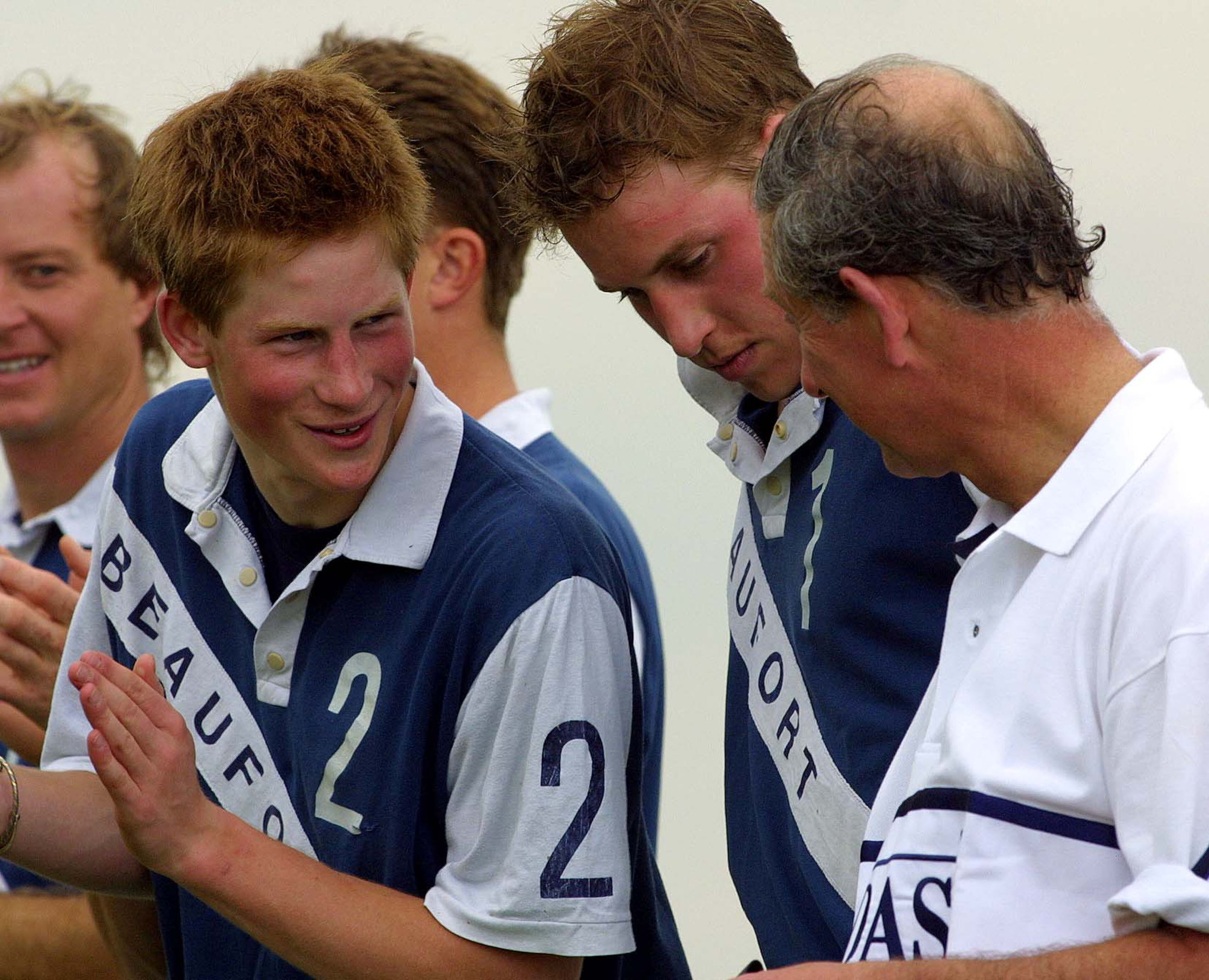 In this June 8, 2002, photo, Britain's Prince Harry shares a joke with Prince William and Prince Charles after playing in the Chakravarty Cup at Beaufort Polo Club, United Kingdom.
