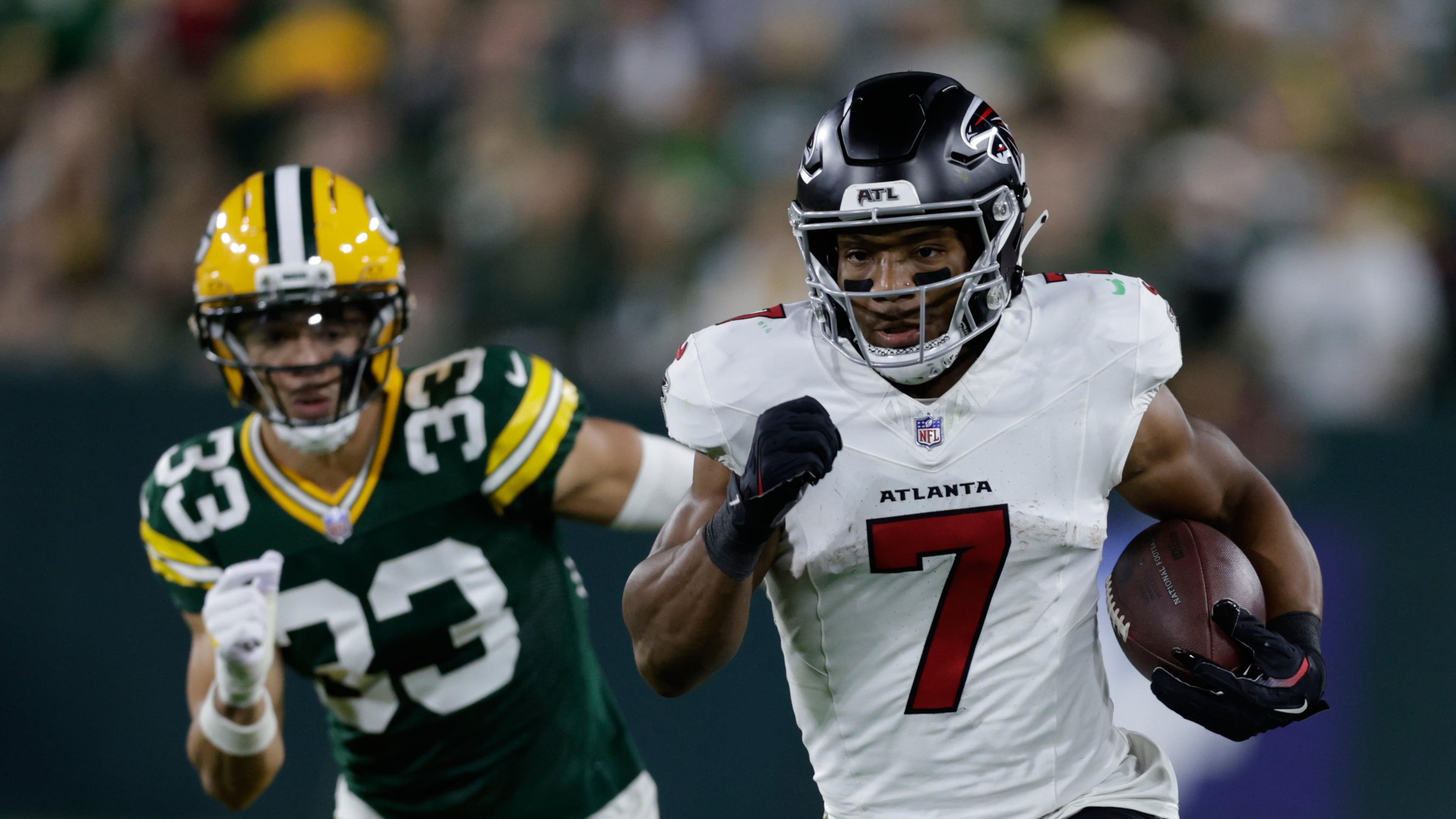 The Falcons' Bijan Robinson (right) runs for a first down past the Packers' Evan Williams during the first half Thursday, Sept. 24, 2026, in Green Bay, Wis. Robinson rushed for 194 yards in the game, the second-most in his career. (Matt Ludtke/AP)
