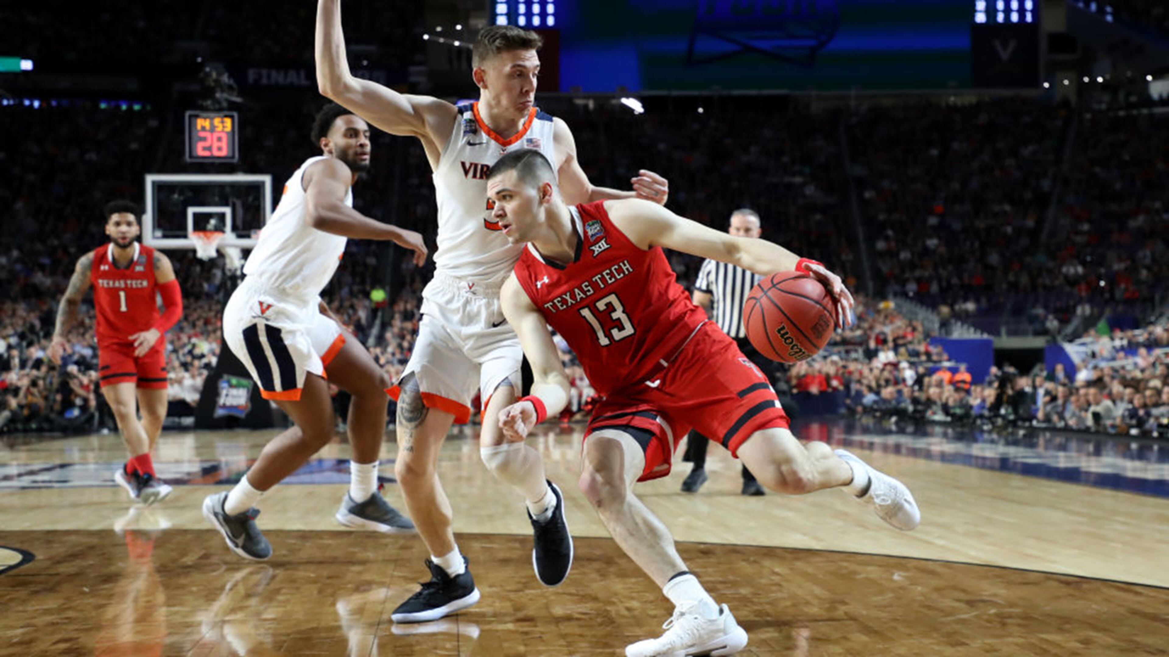 Matt Mooney #13 of the Texas Tech Red Raiders is defended by Kyle Guy #5 of the Virginia Cavaliers in the first half during the 2019 NCAA men's Final Four National Championship game at U.S. Bank Stadium on April 08, 2019 in Minneapolis, Minnesota.