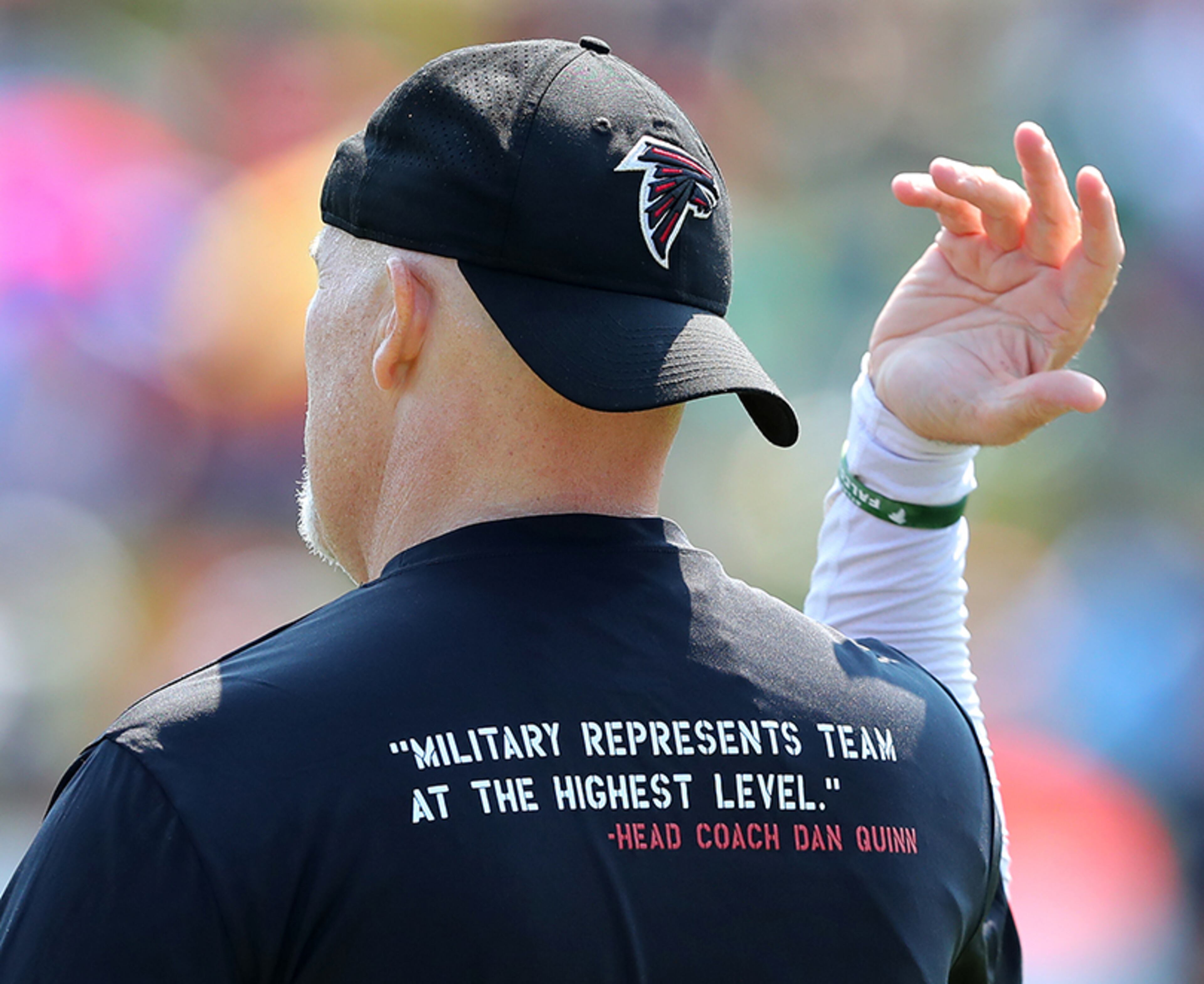 August 6, 2017 Flowery Branch: Falcons head coach Dan Quinn wears a shirt bearing his quote ââ¬Åmilitary represents team at the highest levelââ¬Â during team practice on Military Day, Sunday, August 6, 2017, in Flowery Branch. Curtis Compton/ccompton@ajc.com
