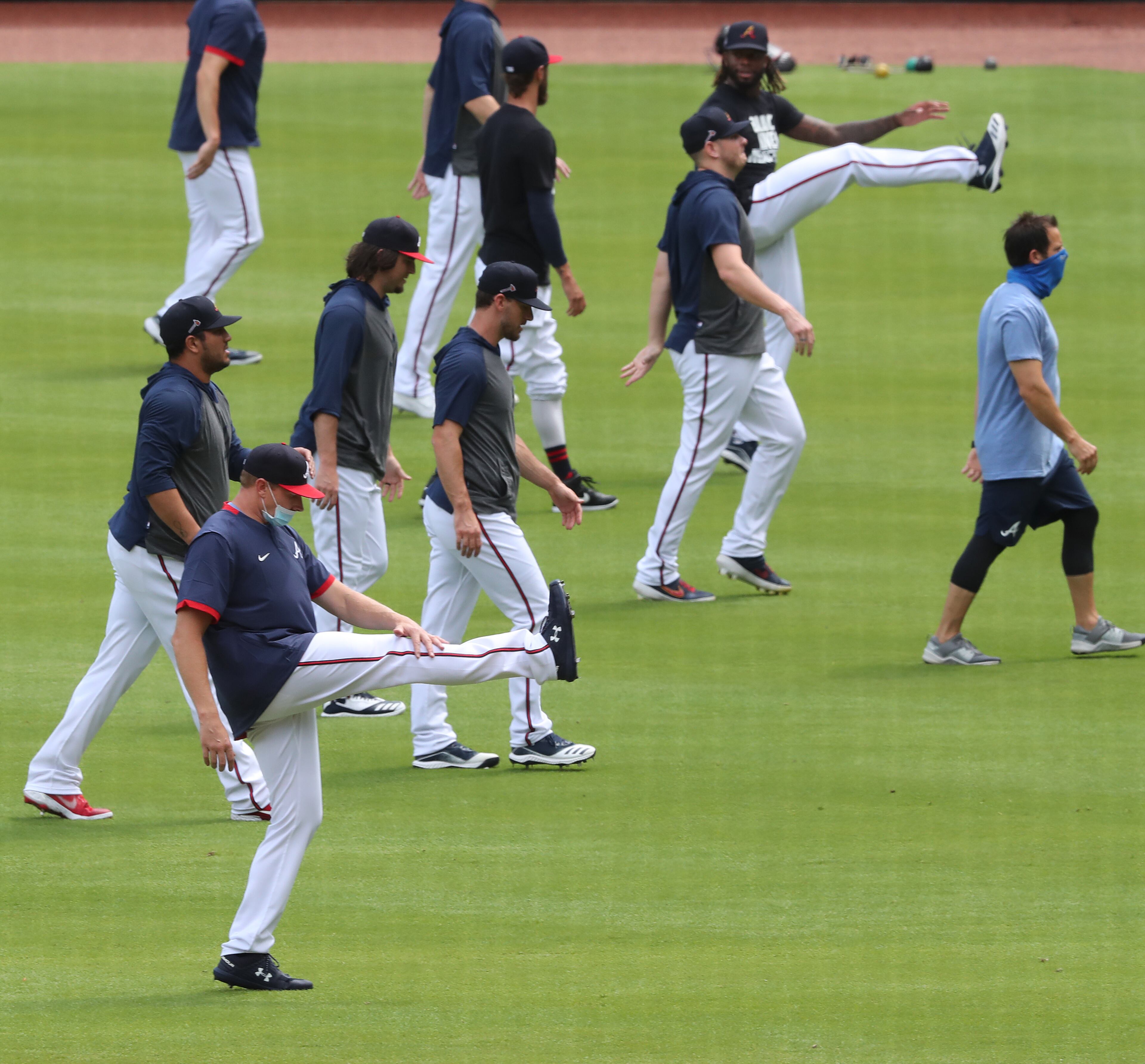 Braves pitchers loosen up as a group before playing the Tampa Bay Rays Thursday, July 30, 2020, at Truist Park in Atlanta.