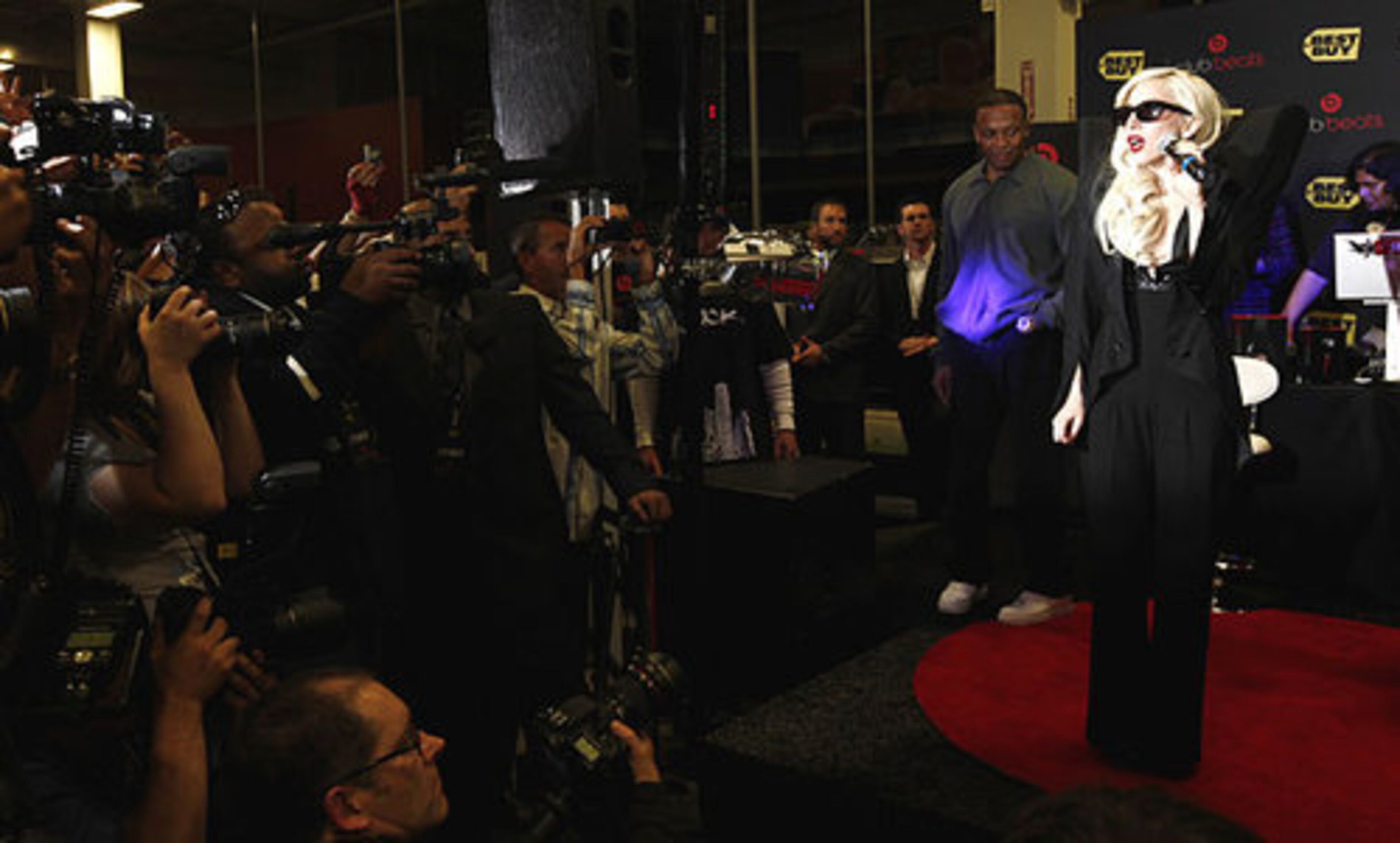 Musician Lady Gaga poses for photographers before signing copies of her new album "The Fame Monster" at a Best Buy store in Los Angeles on Monday, Nov. 23, 2009.