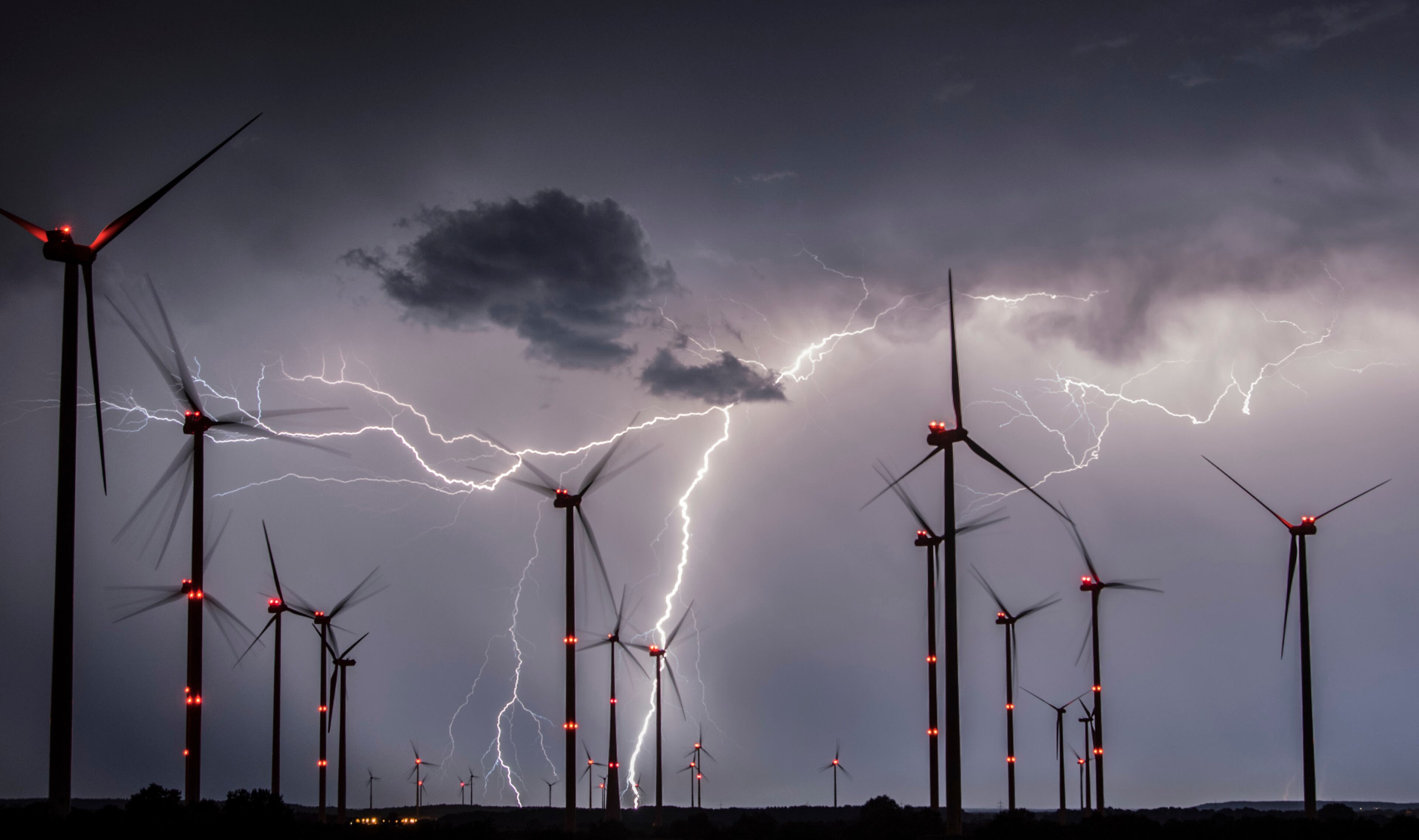 In this Aug. 1, 2017 photo lightning illuminate the night sky over the Odervorland wind farm in the Oder-Spree district near to Sieversdorf, Germany. (Patrick Pleul/dpa via AP)