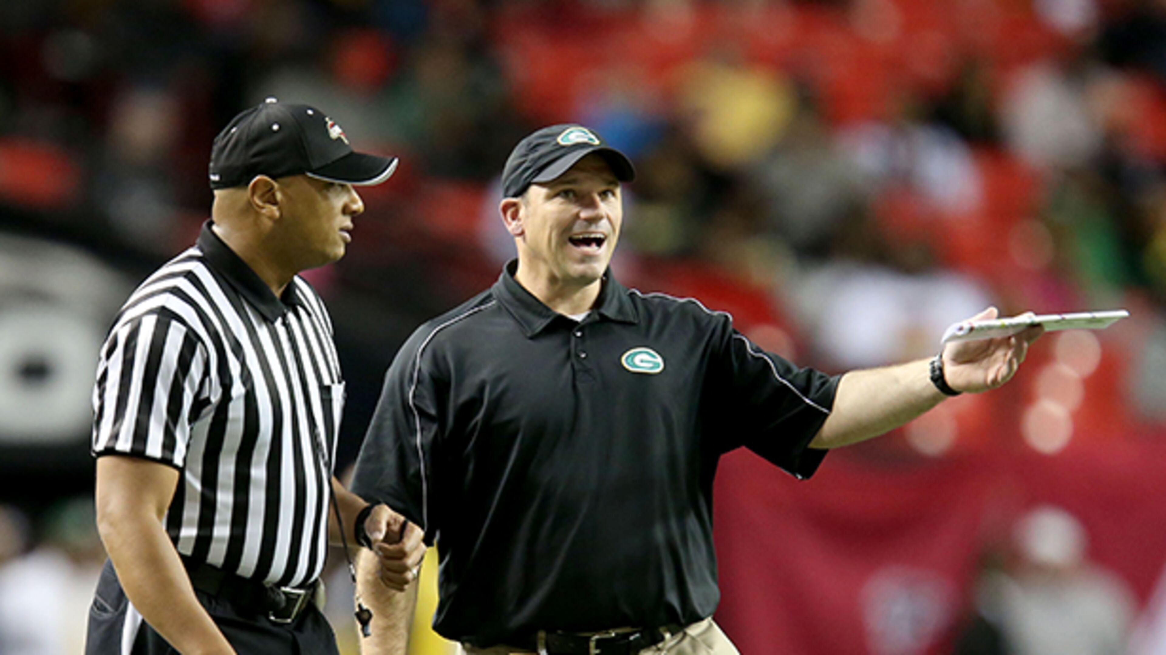 December 14, 2013 - Atlanta, Ga.: Griffin coach Steven DeVoursney, center, argues a call with an official in the first half of their game against Carrollton in the Class AAAA championship game at the Georgia Dome Saturday night in Atlanta, Ga., December 14, 2013. JASON GETZ / JGETZ@AJC.COM Steven DeVoursney was 128-35 in 13 seasons at Griffin. (Jason Getz / AJC File)