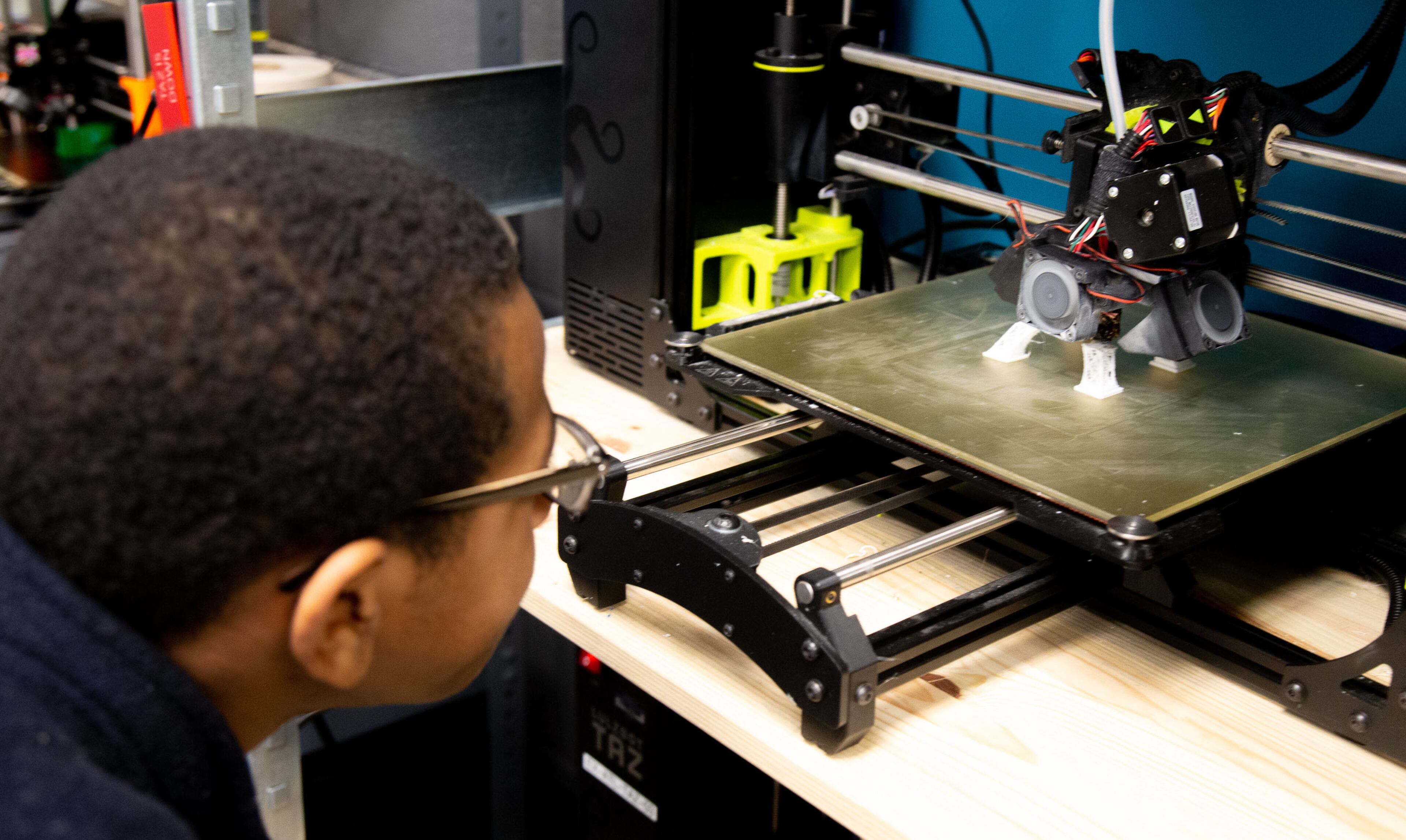 Johnathan Rutherford watches a 3D printer print during the Genius Camp in the ExLab at Georgia State University on Saturday, March 7, 2020. STEVE SCHAEFER / SPECIAL TO THE AJC