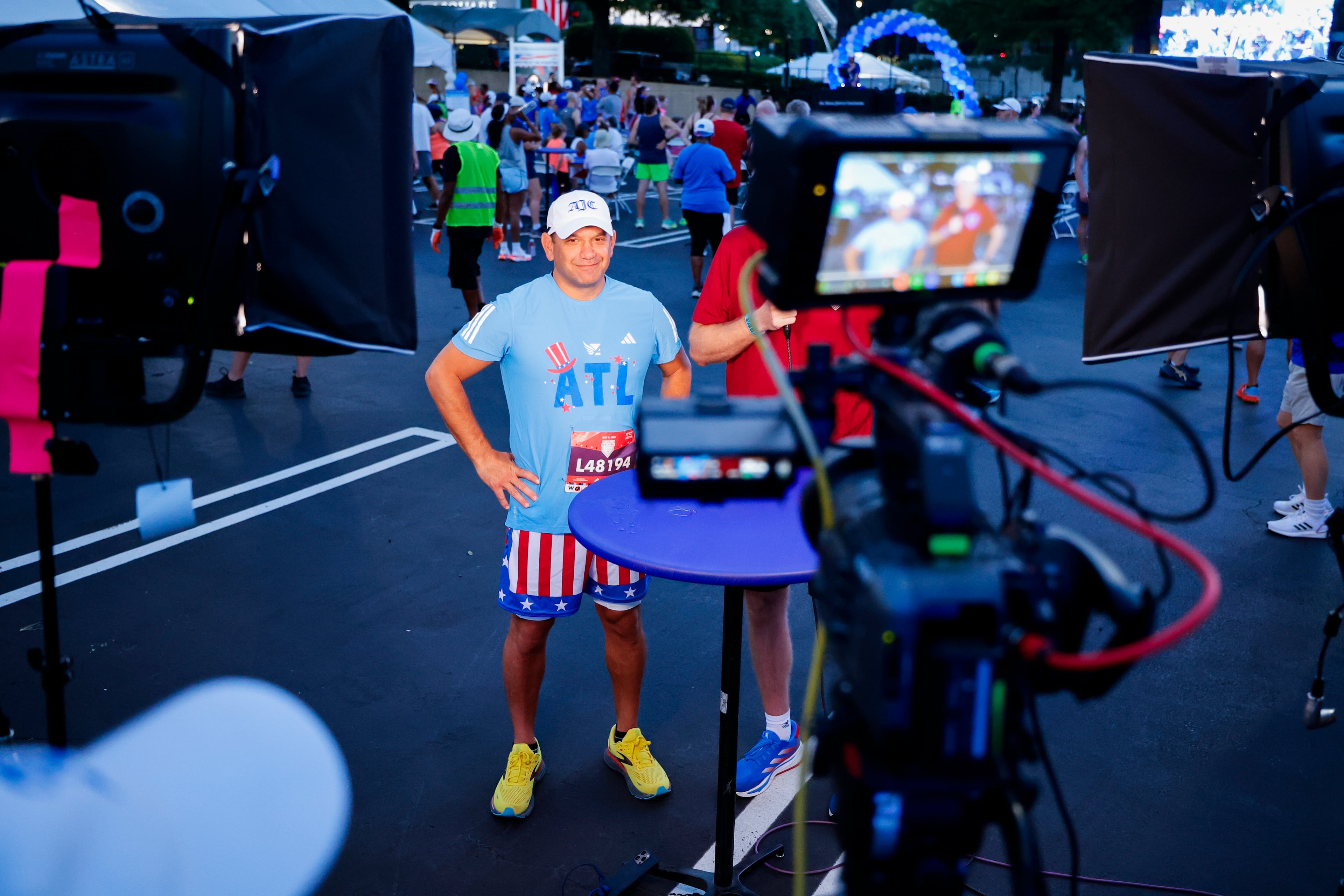 The AJC's Andrew Morse stops for an interview after completing the 2024 Peachtree Road Race. (Paul McPherson for Atlanta Track Club)