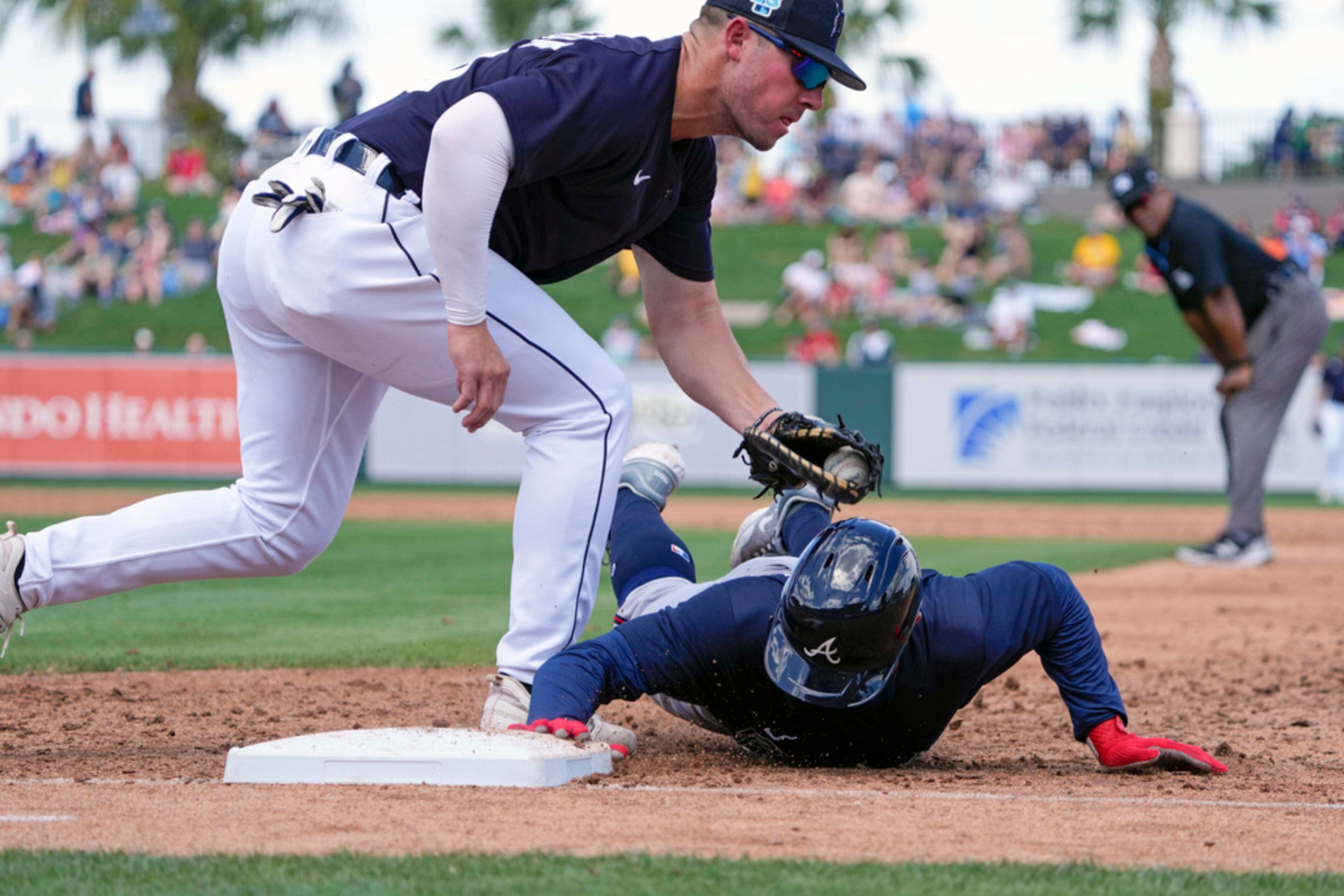 Atlanta Braves' Forrest Wall right is tagged out by Detroit Tigers first baseman Spencer Torkelson on a pick off play in the third inning of a spring training baseball game, Wednesday, March 22, 2023, in Lakeland, Fla. (AP Photo/John Raoux)
