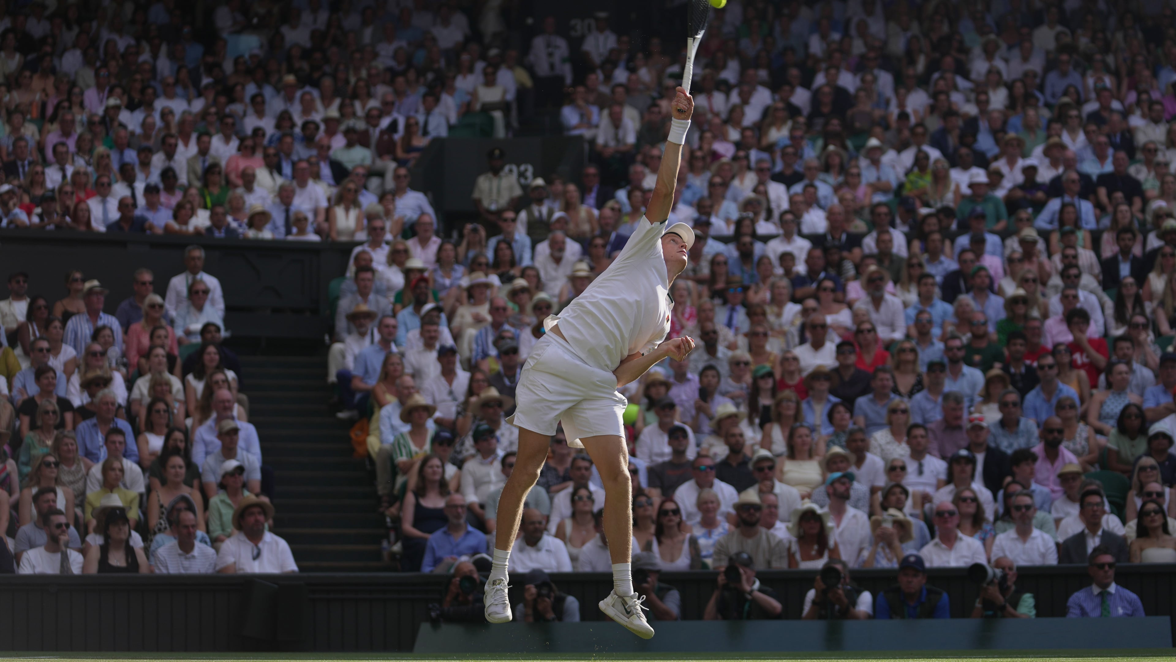 Jannik Sinner of Italy serves to Novak Djokovic of Serbia in their men's singles semifinal match at the Wimbledon Tennis Championships in London, Friday, July 10, 2026. (AP Photo/Brian Inganga)