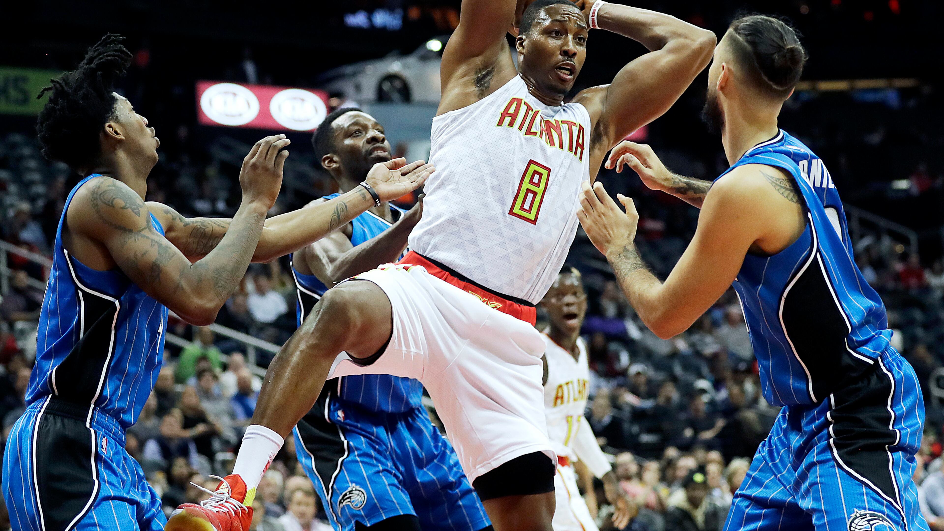 Atlanta Hawks’ Dwight Howard (8) grabs a rebound against the defense of Orlando Magic’s Elfrid Payton, from left, Jeff Green, and Evan Fournier, of France in the second quarter of an NBA basketball game in Atlanta, Tuesday, Dec. 13, 2016. (AP Photo/David Goldman)