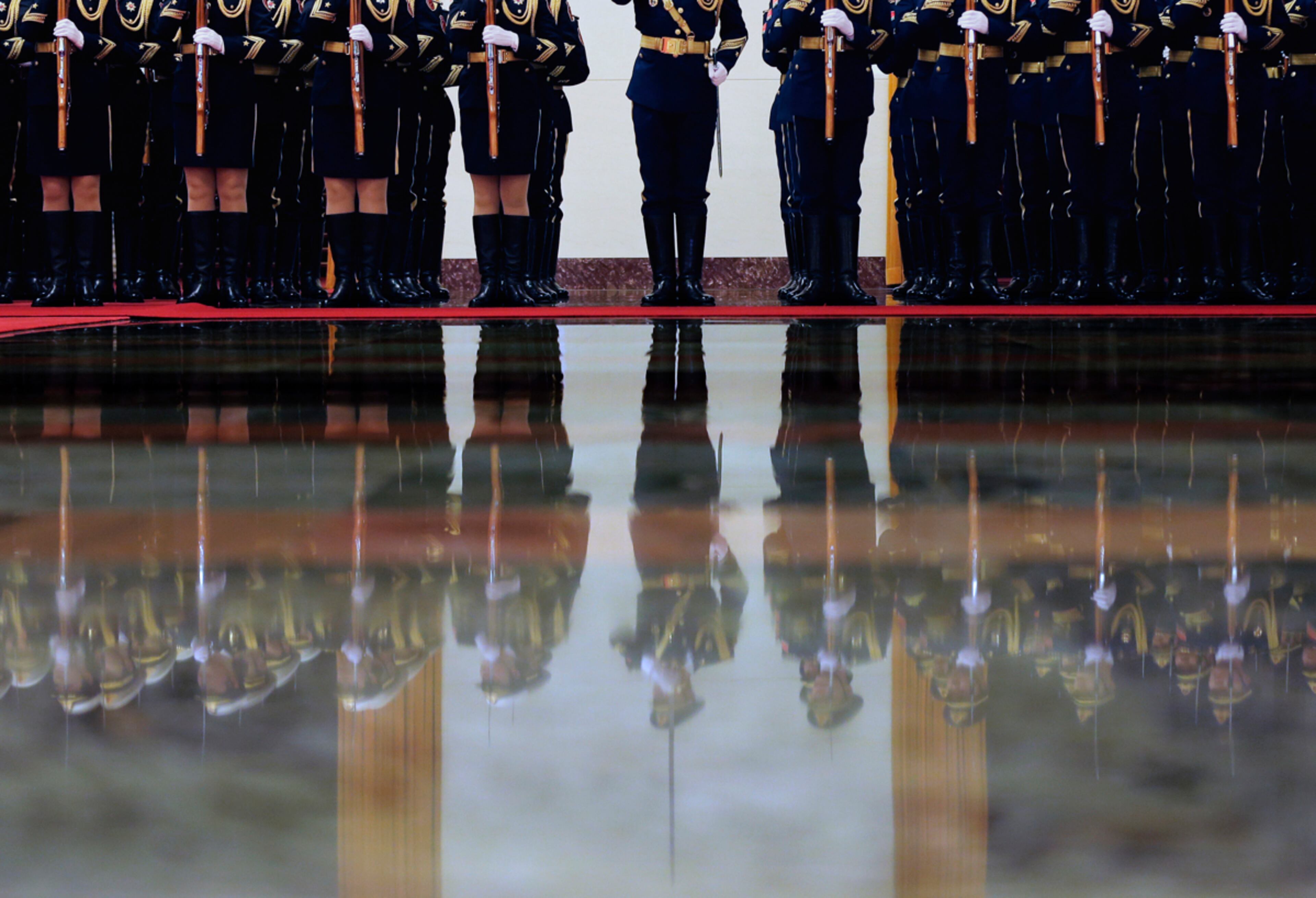 REFLECTIONS OF HONOR--Chinese guard of honor members are reflected on the floor as they rehearse for a welcome ceremony for visiting Thailand's Prime Minister Prayuth Chan-ocha at the Great Hall of the People in Beijing, China Monday, Dec. 22, 2014. (AP Photo/Andy Wong)