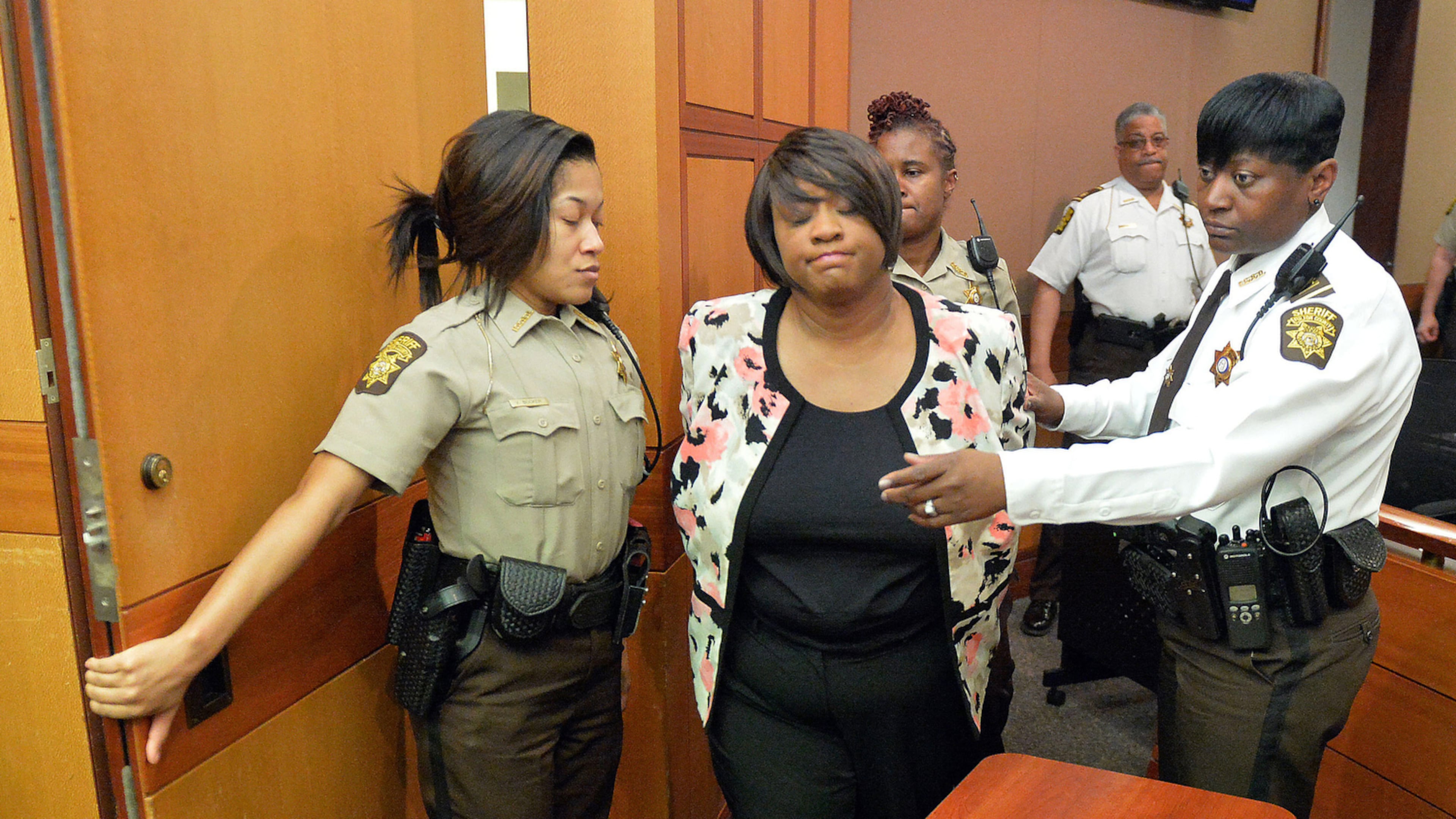 Tamara Cotman is led to a holding cell after a jury found her guilty in the Atlanta Public Schools test-cheating trial in 2015. (Kent D. Johnson/ Atlanta Journal-Constitution)
