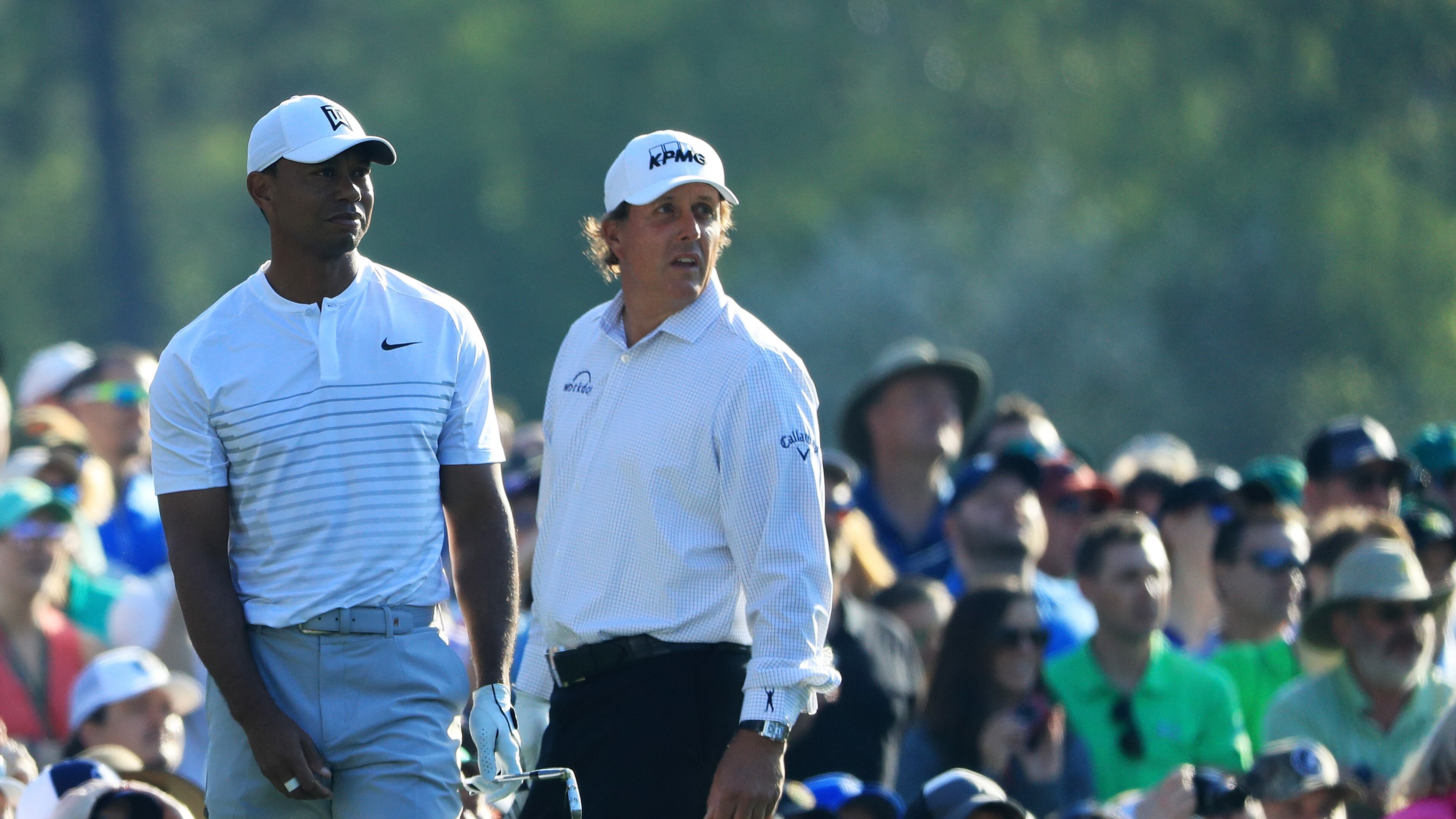 The new "it" couple of the 2018 Masters: Phil Mickelson and Tiger Woods cohabit the 12th tee during their Tuesday practice round. (Andrew Redington/Getty Images)