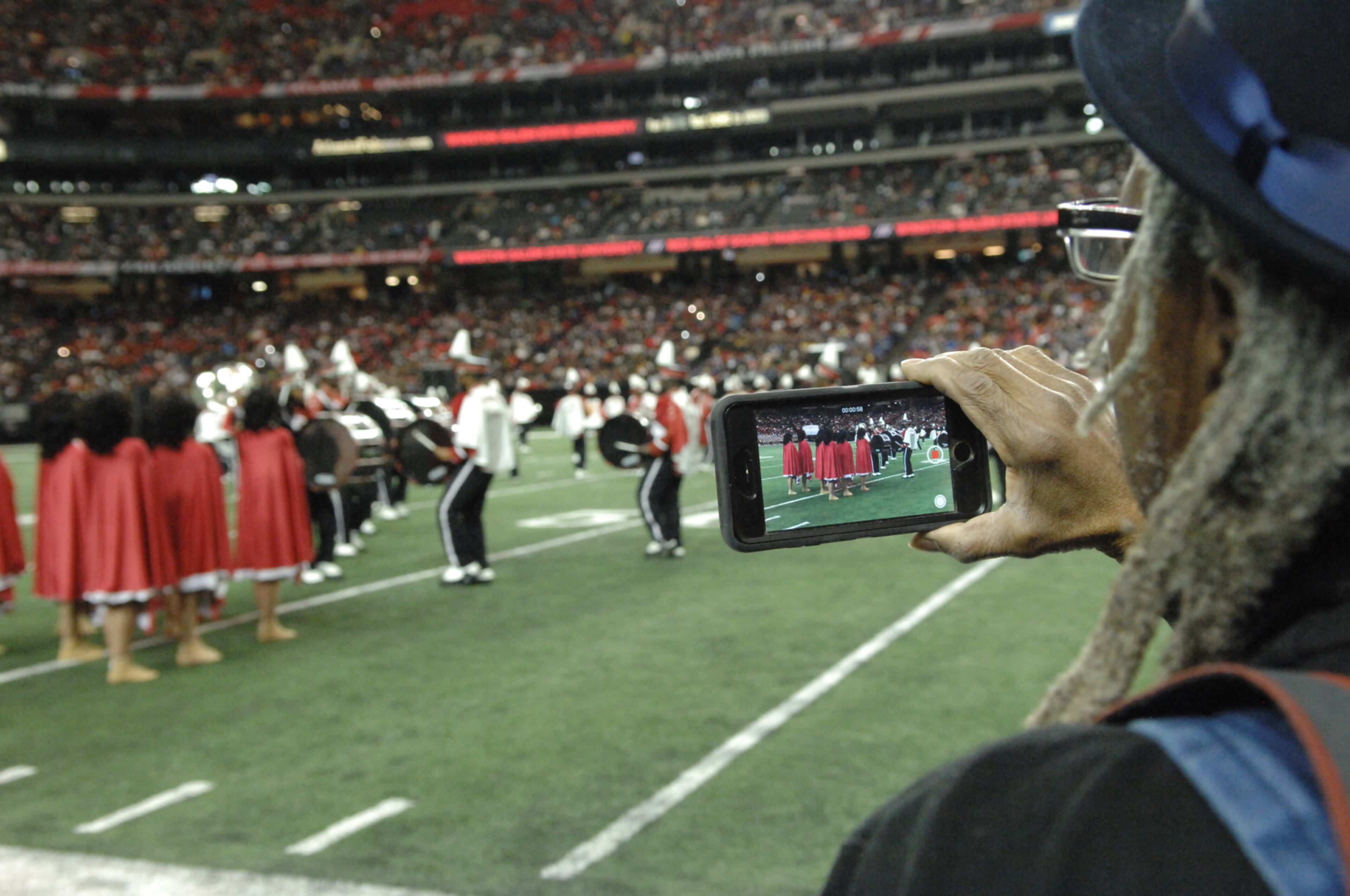 012817 Ed White of Louisville Ky. records some of Winston Salem's performance. Battle of the Bands at the Georgia Dome in Atlanta. W.A. Bridges Jr. special