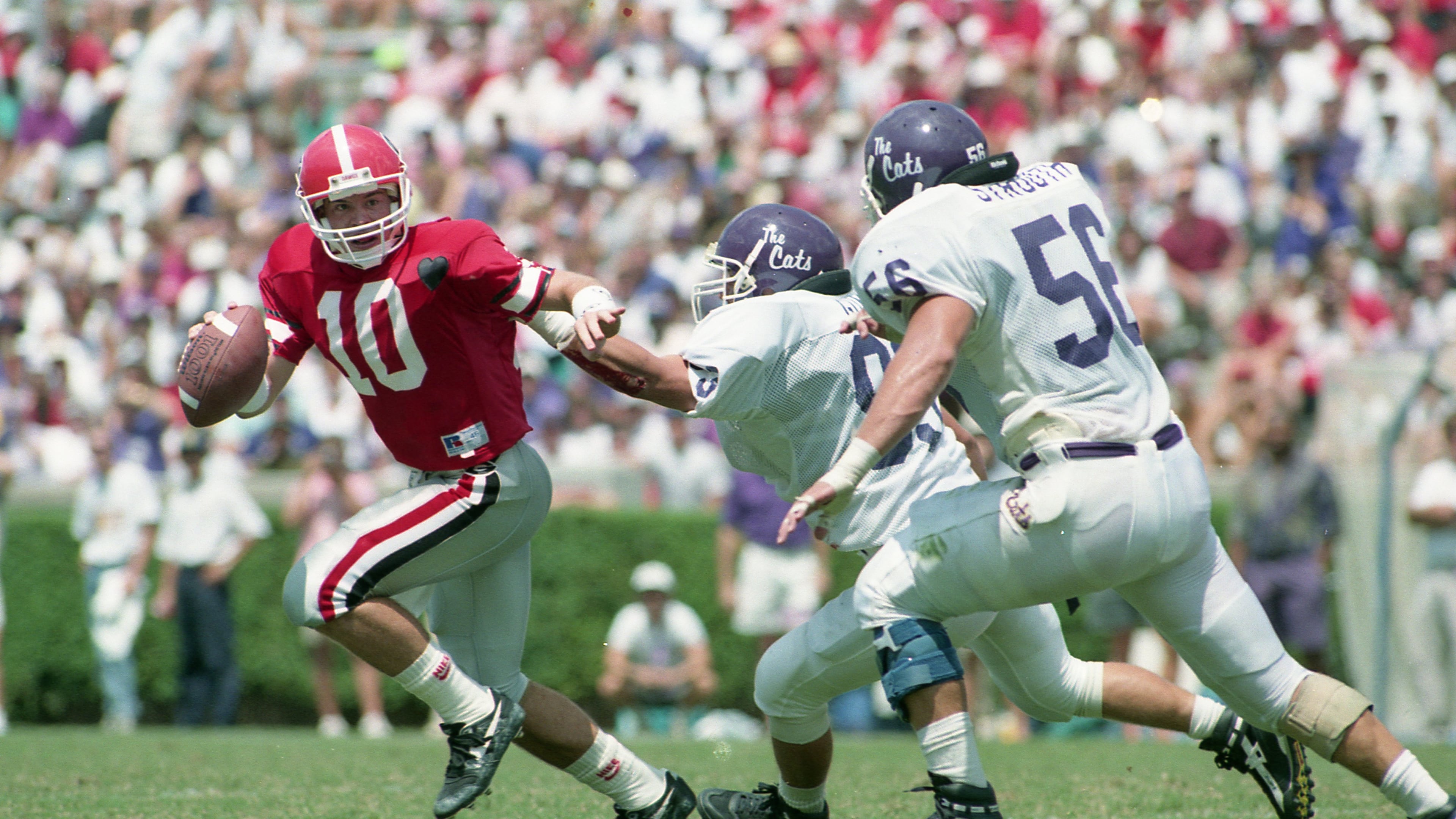 Former Georgia quarterback Eric Zeier (left) is bullish on the Bulldogs this season. “What Kirby (Smart) has done with this program is no different than what (Nick) Saban did at Alabama, raise the standard of what excellence looks like,” Zeier says. (Joey Ivansco/AJC File)