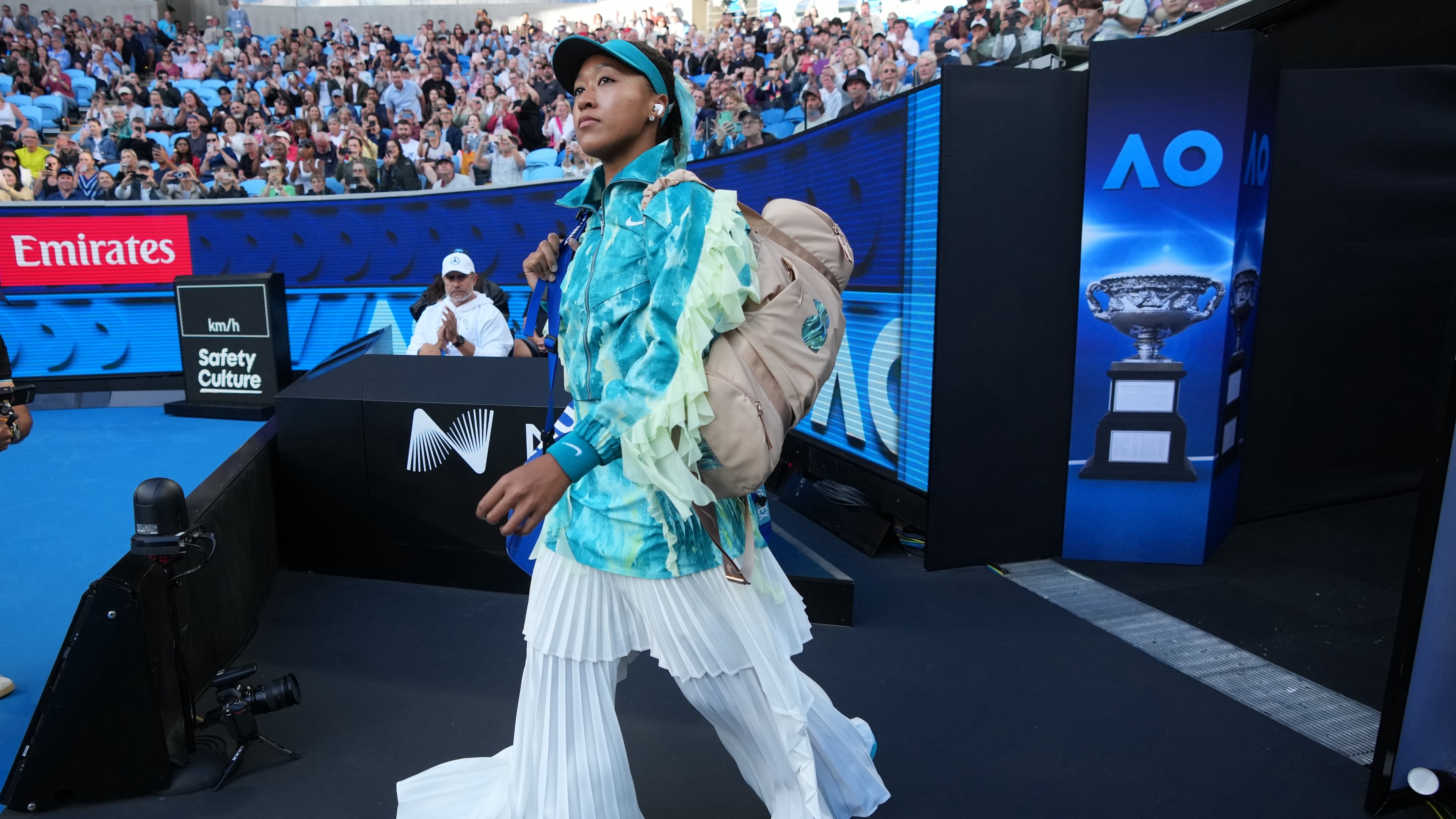 Naomi Osaka of Japan walks onto court for her second round match against Sorana Cirstea of Romaniaat the Australian Open tennis championship in Melbourne, Australia, Thursday, Jan. 22, 2026. (AP Photo/Dita Alangkara)