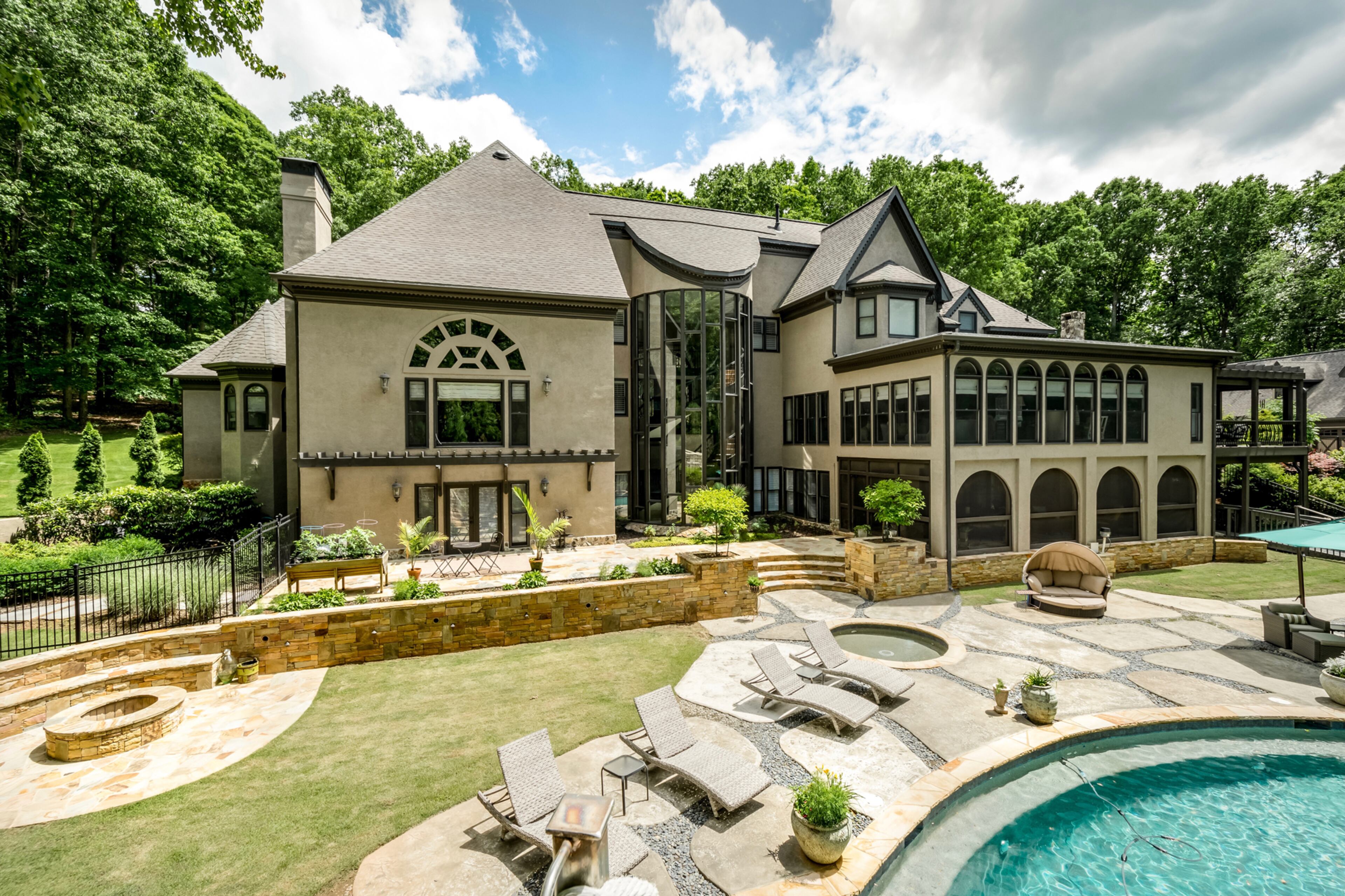 A fun-filled backyard with a 12-foot pool, water slide, hot tub, water fountain and wading pool all waiting for summer fun. Text by Melanie White.