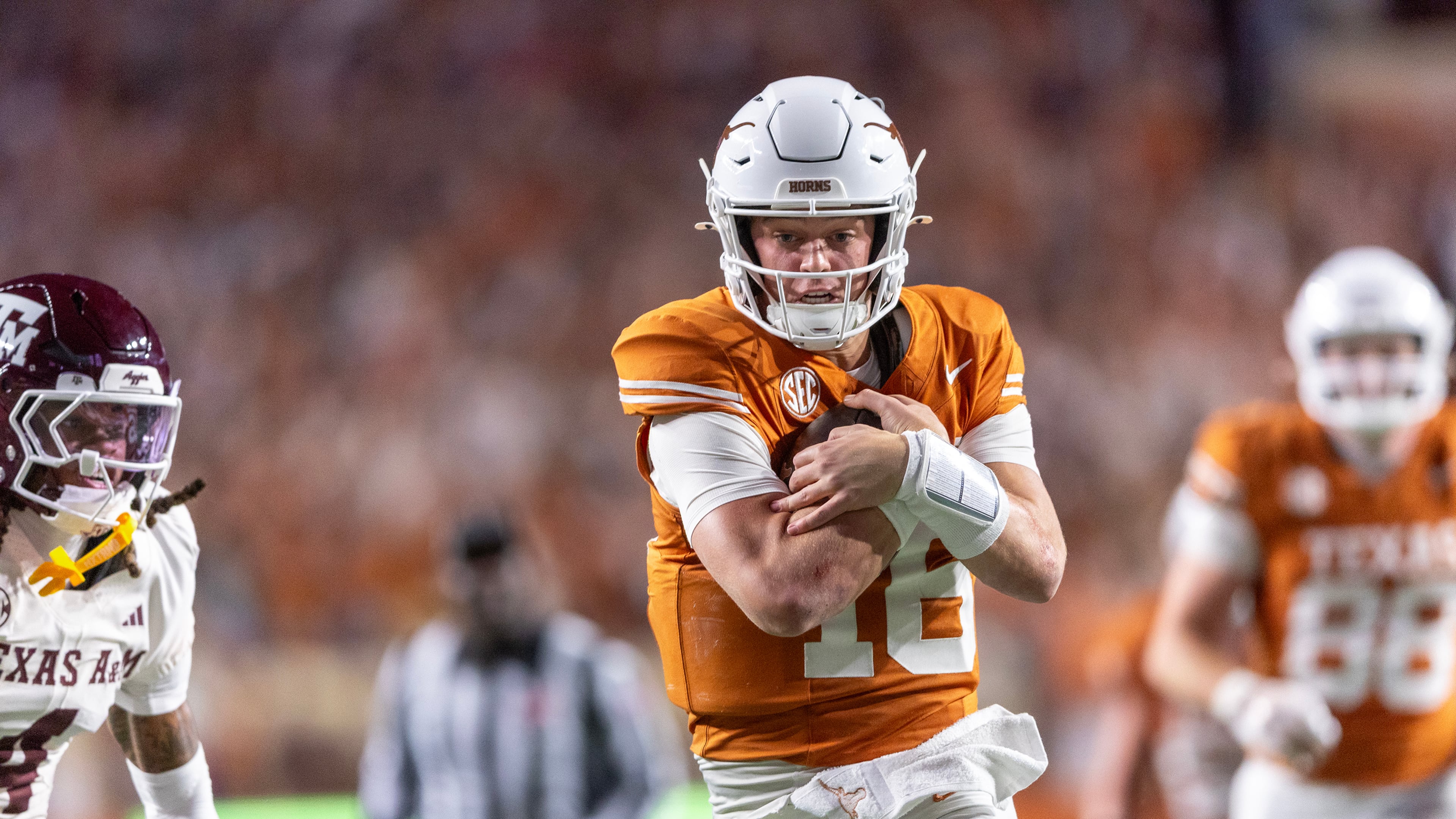 FILE - Texas quarterback Arch Manning (16) scores a touchdown past Texas A&M cornerback Will Lee III (4) during the second half of an NCAA college football game Friday, Nov. 28, 2025, in Austin, Texas. (AP Photo/Stephen Spillman, File)