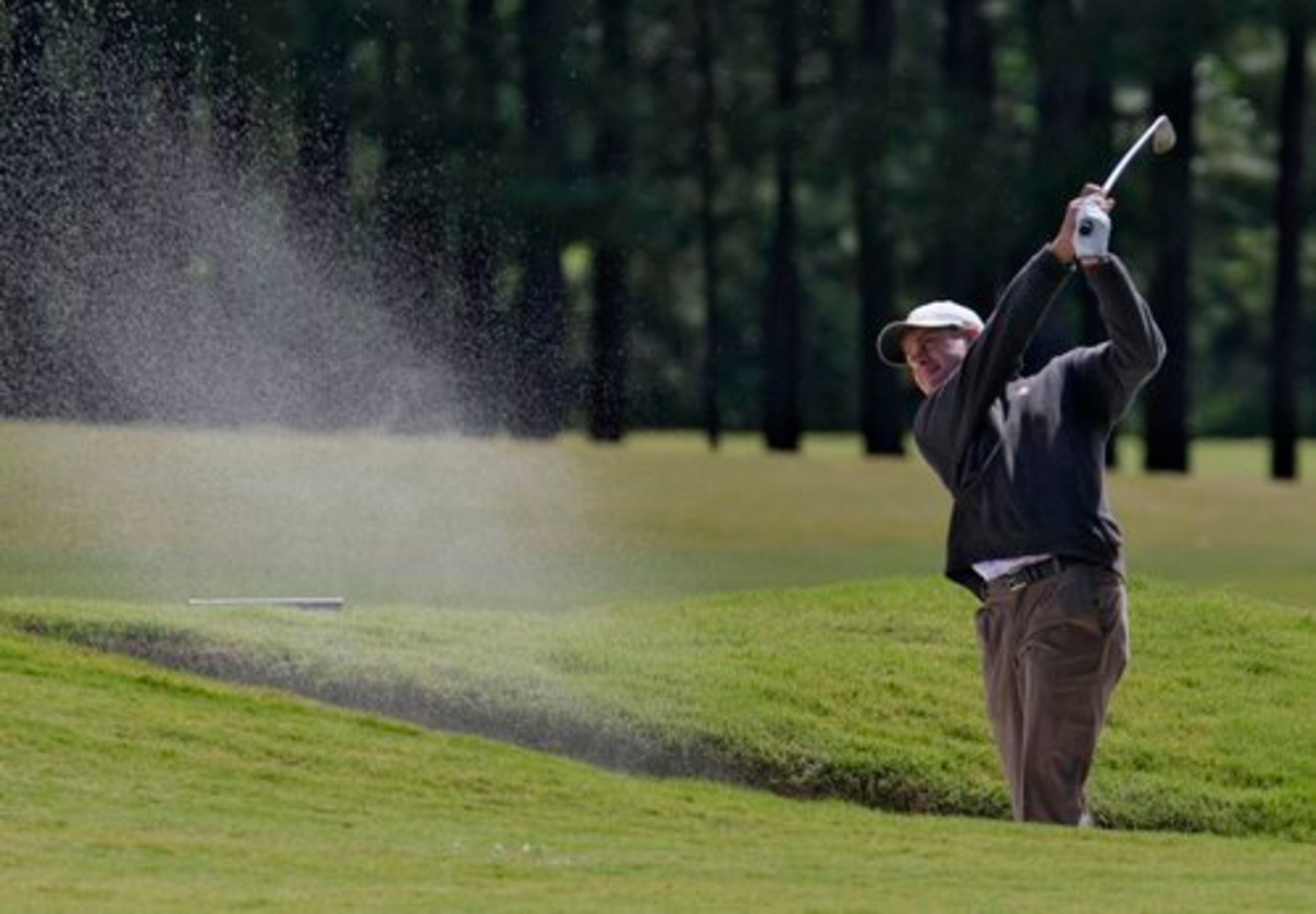 UGA's Harris English hits from a fairway trap on 15. John Smoltz was among those trying to qualify for the U.S. Open in a qualifying tournament in Suwanee today. Tuesday May 17, 2011