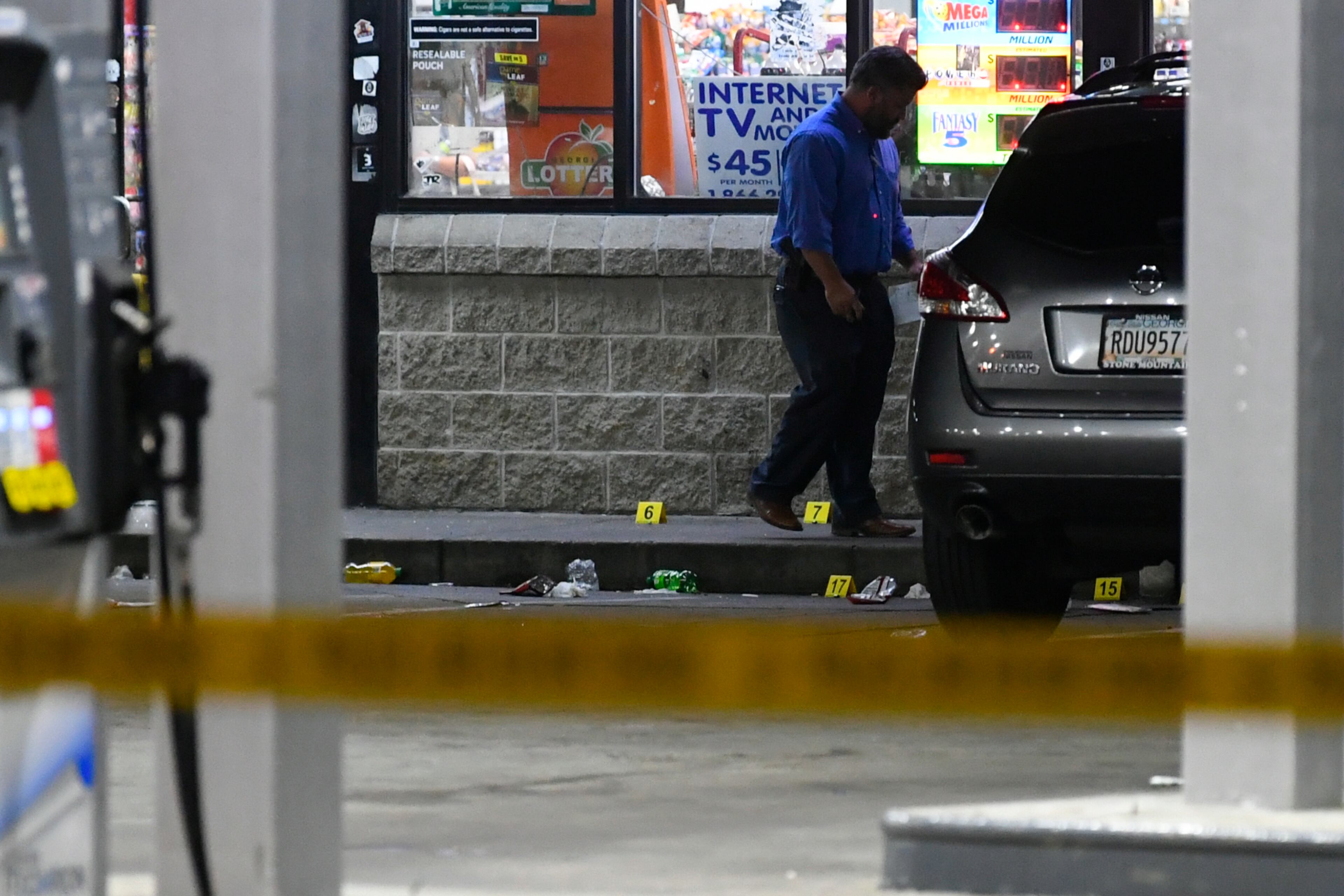Law Enforcement investigate the site of a multiple shooting as a body lies in the parking lot of a gas station on Pryor Road in Atlanta on Sunday, July 5, 2020. JOHN AMIS FOR THE ATLANTA JOURNAL-CONSTITUTION