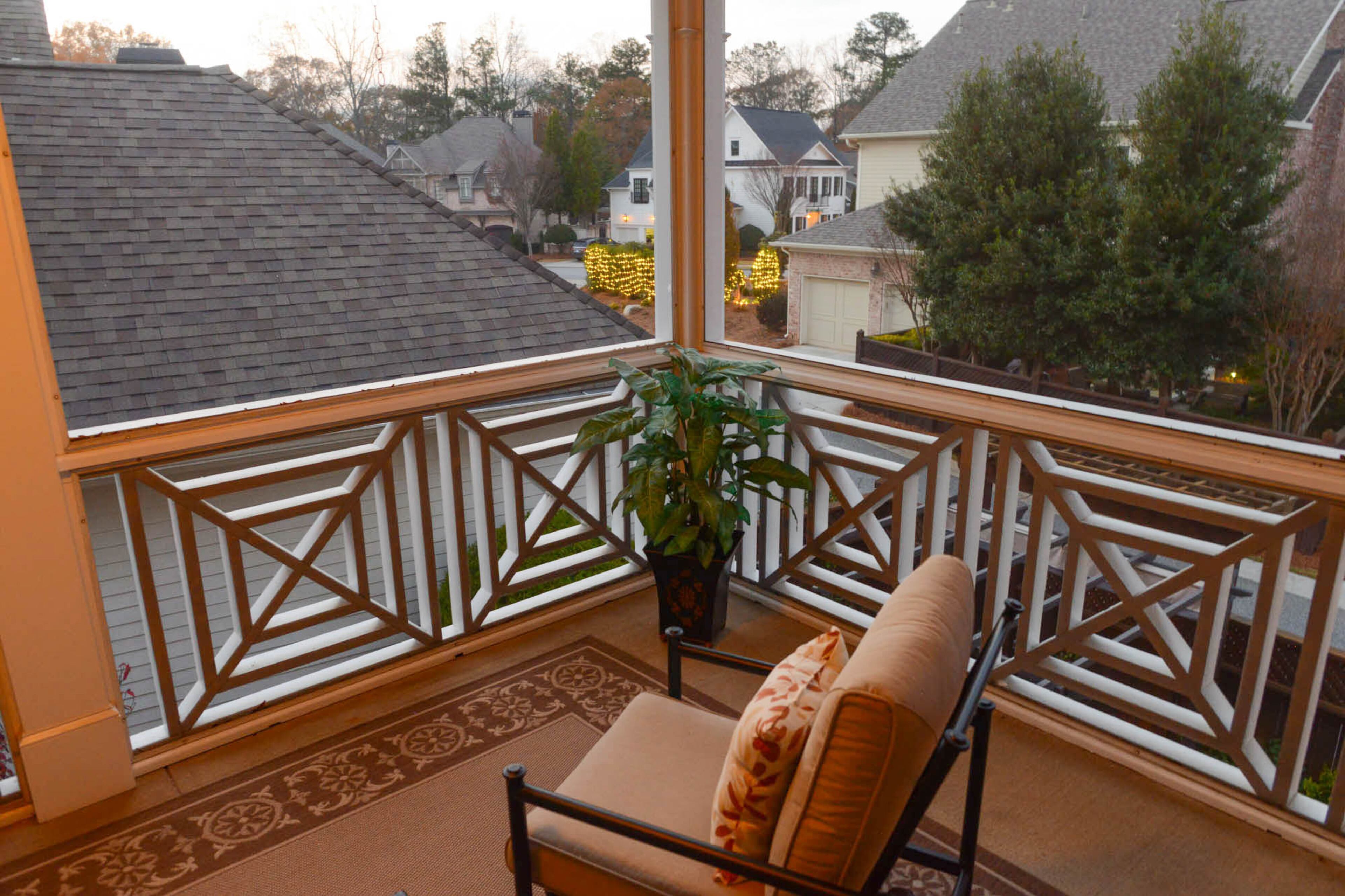 The front porch gets of dose of holiday cheer with Christmas pillows on the iron bench and a festive bowed wreath.
