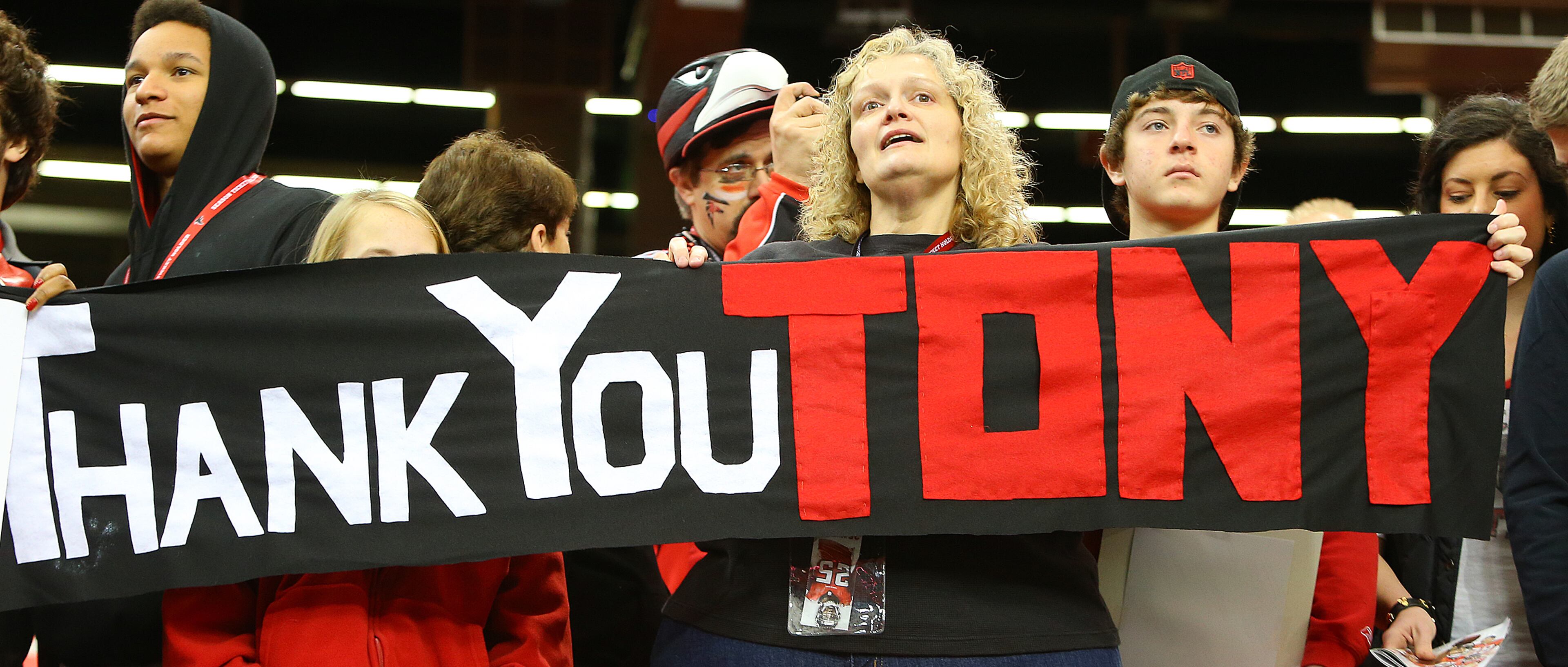 Deborah Beck holds a banner is support of Falcons tight end Tony Gonzalez during the final game of his 17-year NFL career on Sunday, Dec. 29, 2013, in Atlanta.