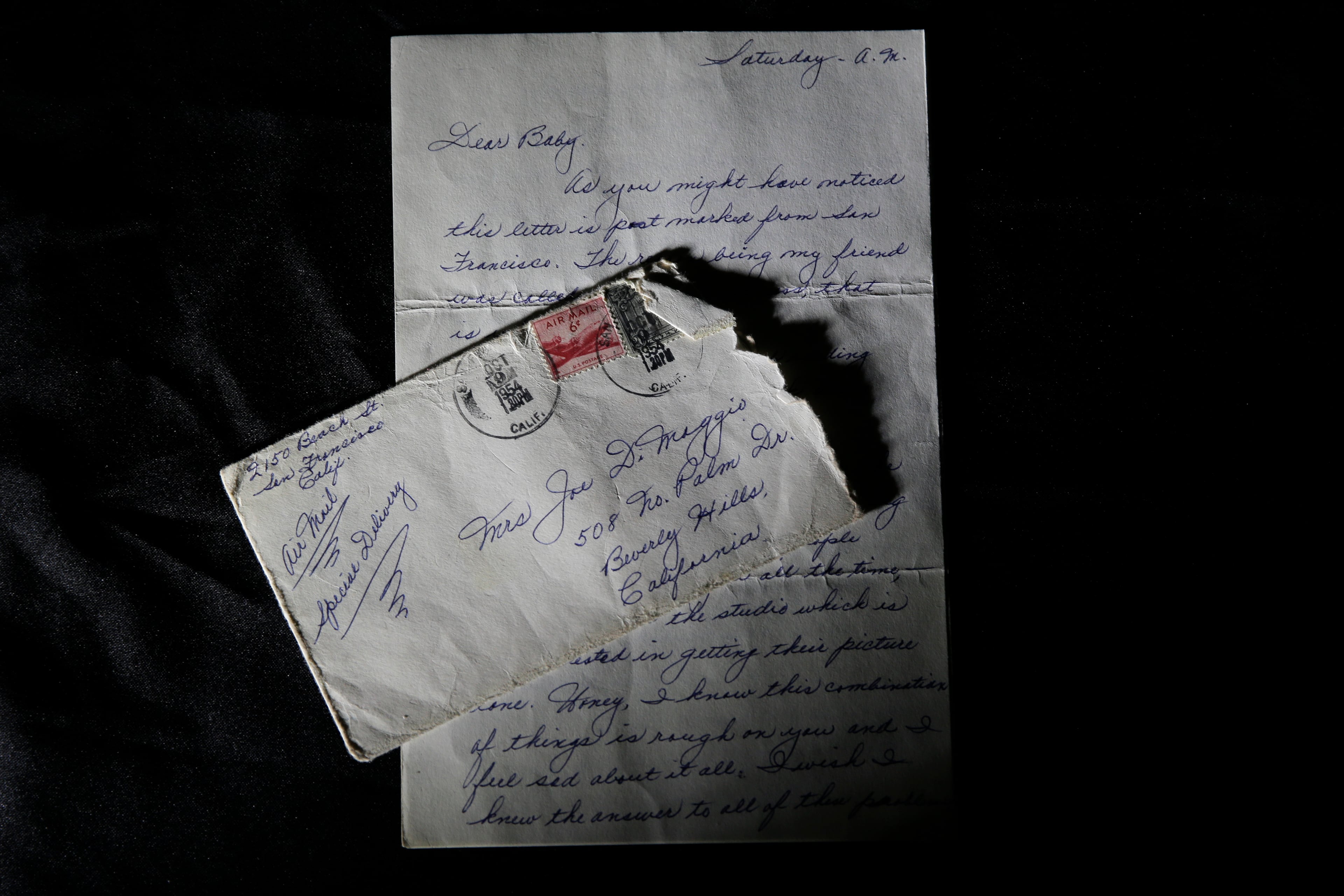 This Nov. 7, 201.4 photo shows part of a three-page handwritten letter and original envelope postmarked Oct. 9, 1954, from baseball legend Joe DiMaggio to Marilyn Monroe on display at Julien's Auctions in Beverly Hills, Calif. The letter is among the 300 items that are part of "Marilyn Monroe's Lost Archives" that go up for bid at Julien's Auctions in Beverly Hills on Dec. 5-6, 2014. (AP Photo/Jae C. Hong)