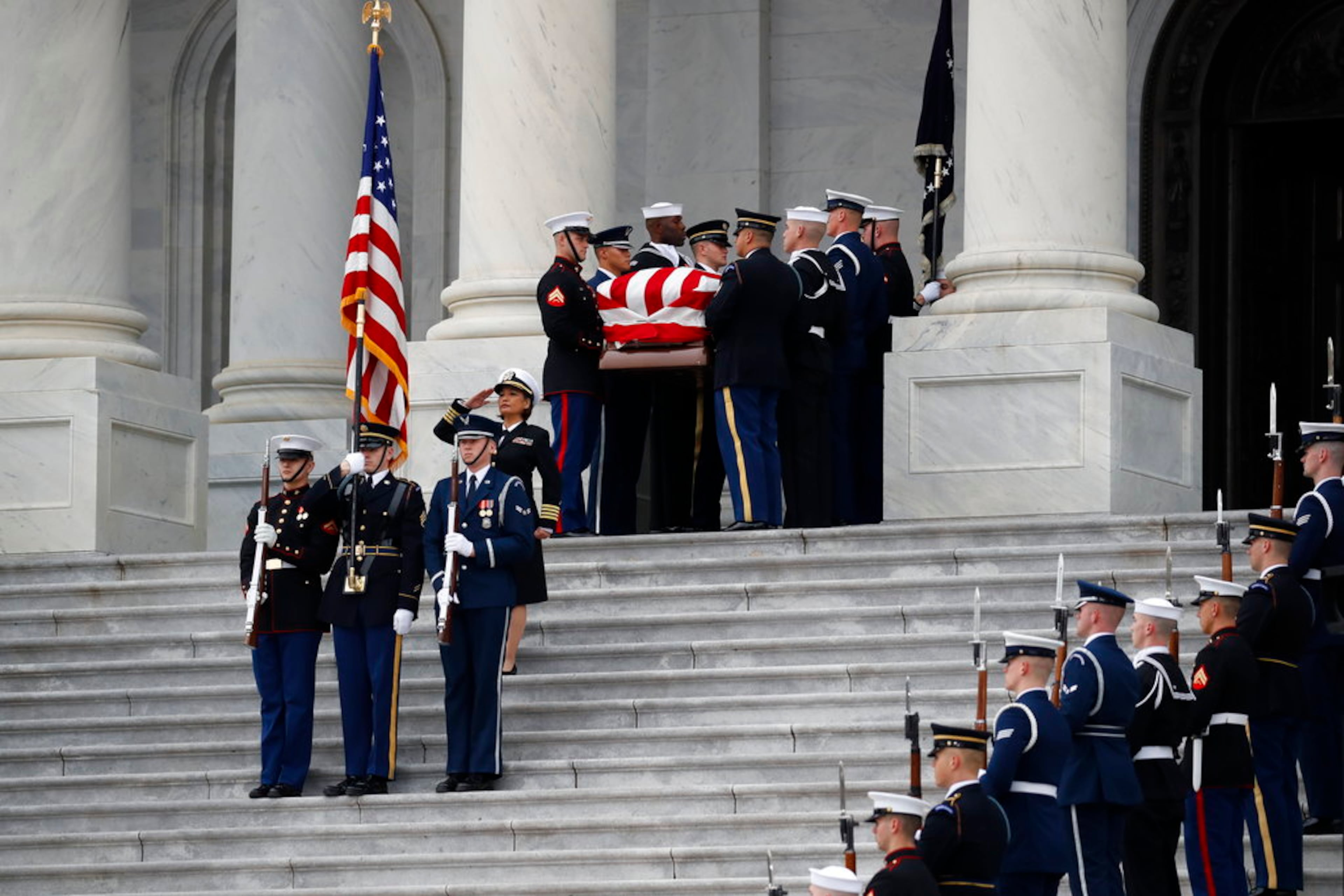 The flag-draped casket of former President George H.W. Bush is carried by a joint services military honor guard from the U.S. Capitol, Wednesday, Dec. 5, 2018, in Washington. (AP Photo/Alex Brandon, Pool)