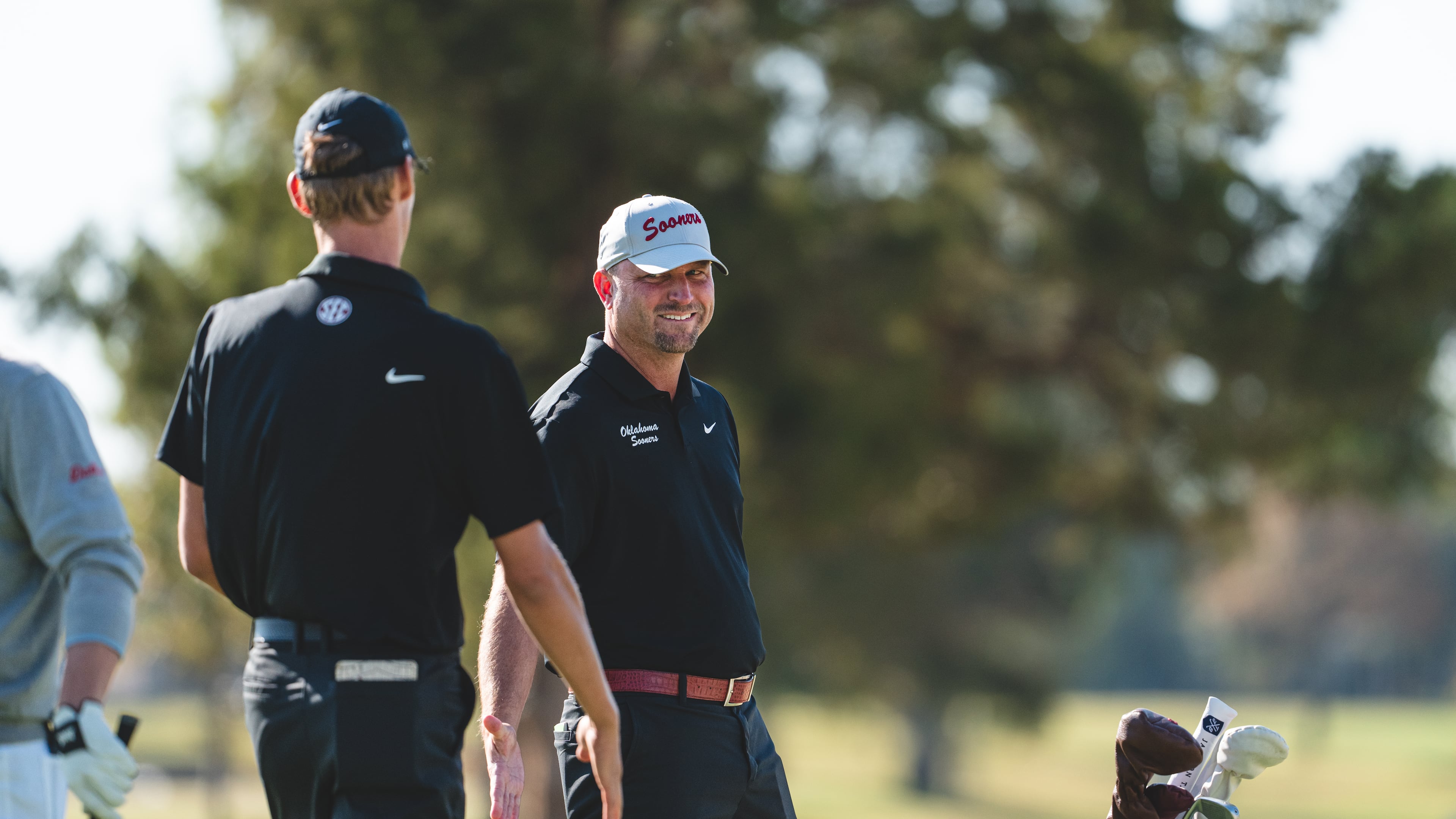 Oklahoma men's golf coach Ryan Hybl (center) was named Georgia Tech's new golf coach Sunday, May 24, 2026. He will succeed Bruce Heppler, who retired after 31 seasons at the helm of the Yellow Jackets' highly successful program. (Courtesy of Oklahoma Athletics)