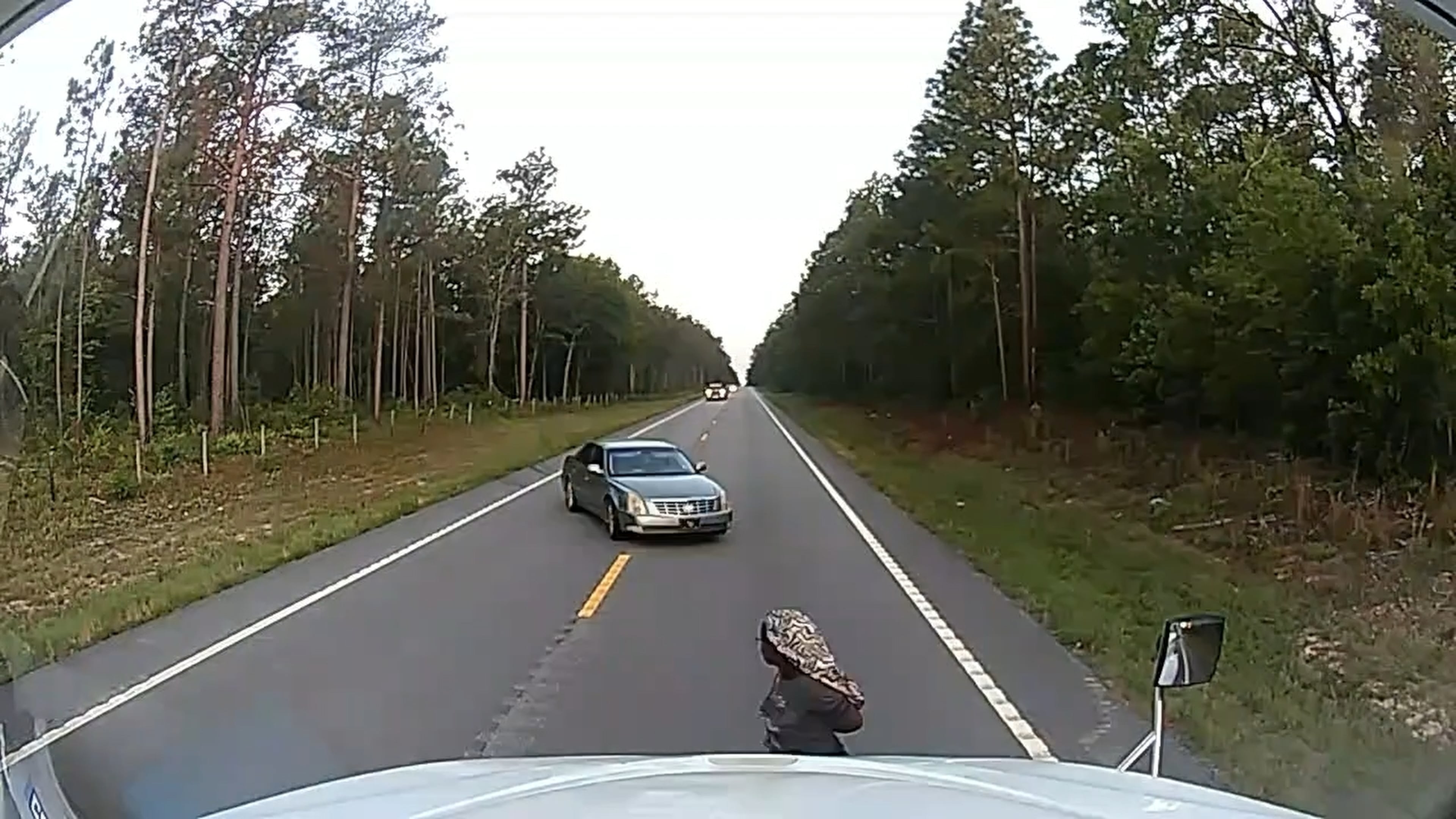 In this frame grab from a dashboard camera video, a cuffed woman is seen running away from her alleged kidnapper near Aiken, S.C., on Friday, May 29, 2026. (Anthony J. Moore via AP)