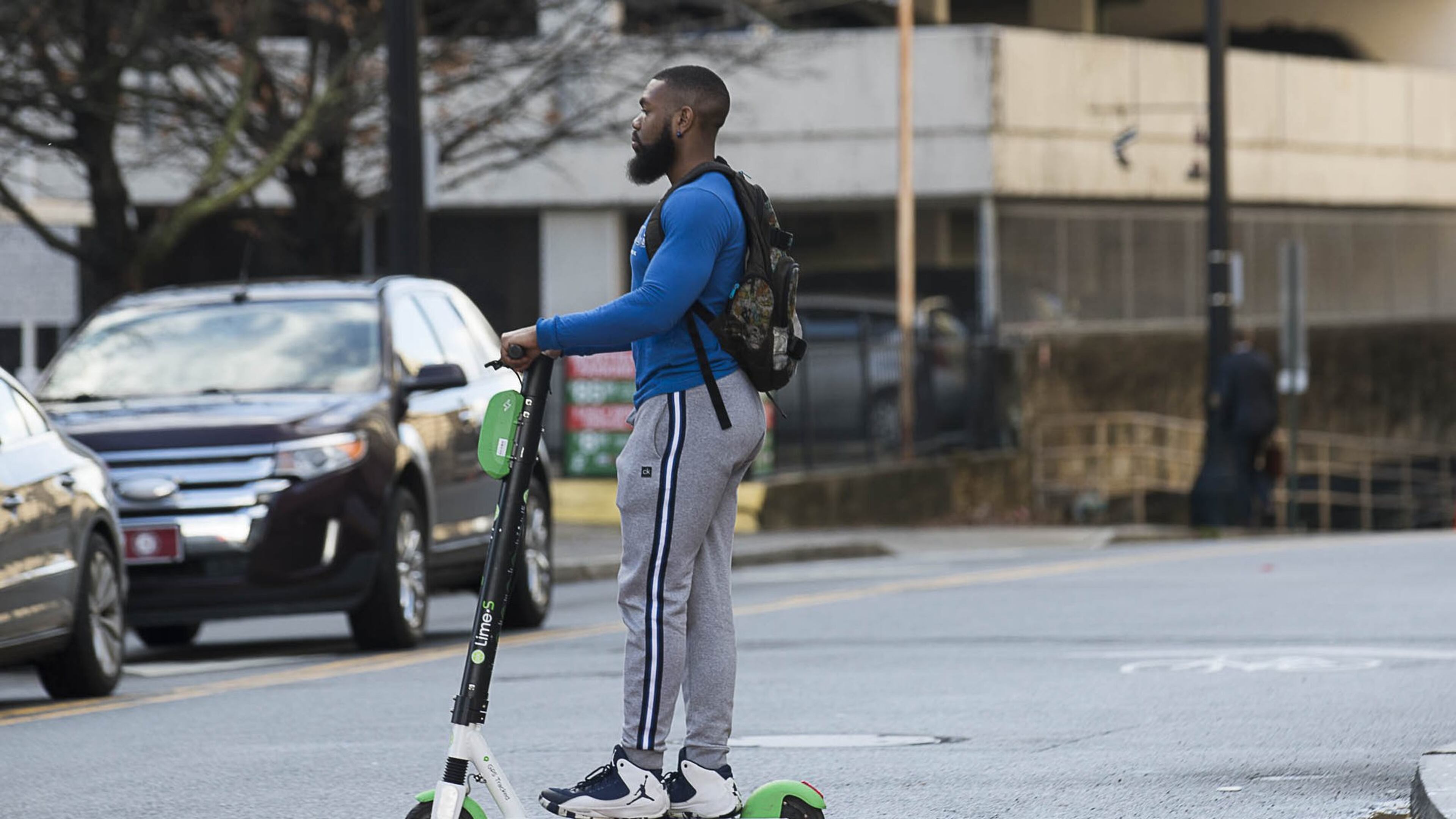 01/04/2019 — Atlanta, Georgia — A man rides a Lime Scooter on Peachtree Street in Atlanta’s Midtown community, Friday, January 4, 2019. (ALYSSA POINTER/ALYSSA.POINTER@AJC.COM)