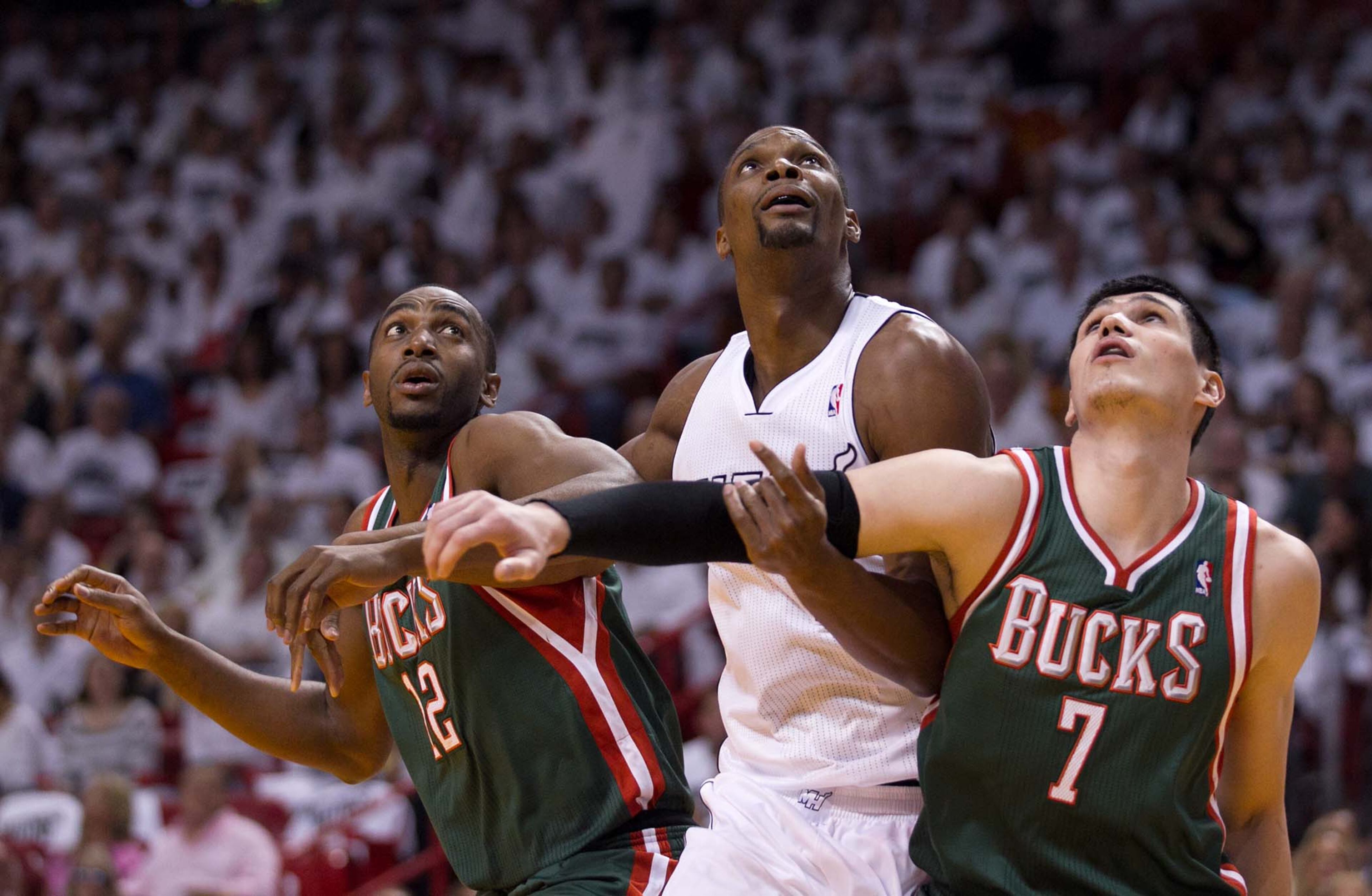 Miami Heat center Chris Bosh (1) battles Milwaukee Bucks power forward Luc Richard Mbah a Moute (12) and Milwaukee Bucks small forward Ersan Ilyasova (7) for rebound position at AmericanAirlines Arena on April 21, 2013. (Allen Eyestone/The Palm Beach Post)