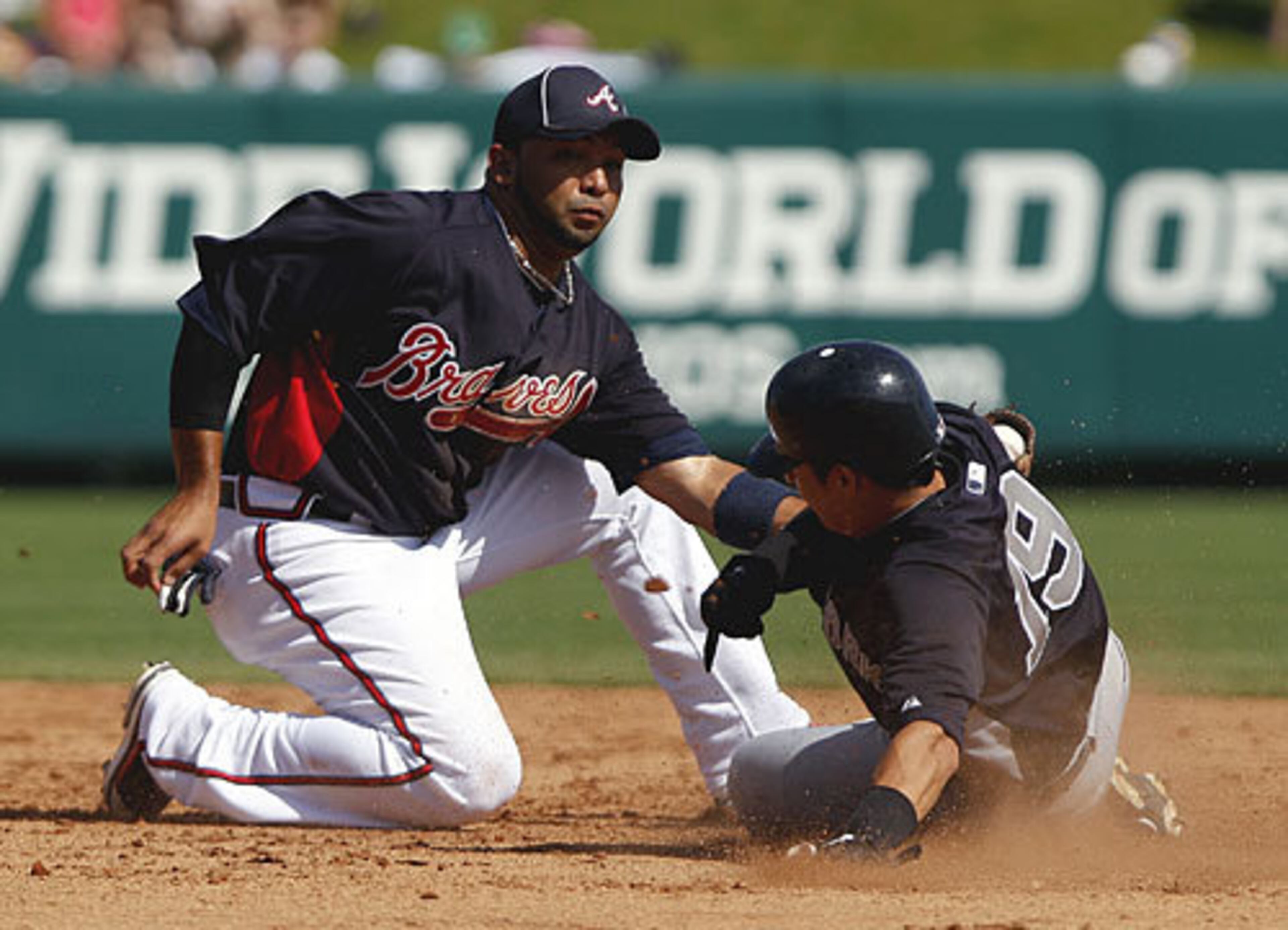 Braves shortstop Alex Gonzalez, left, tags out New York Yankees' Ramiro Pena at second base during the sixth inning. The Yankees beat the Braves 5-4.