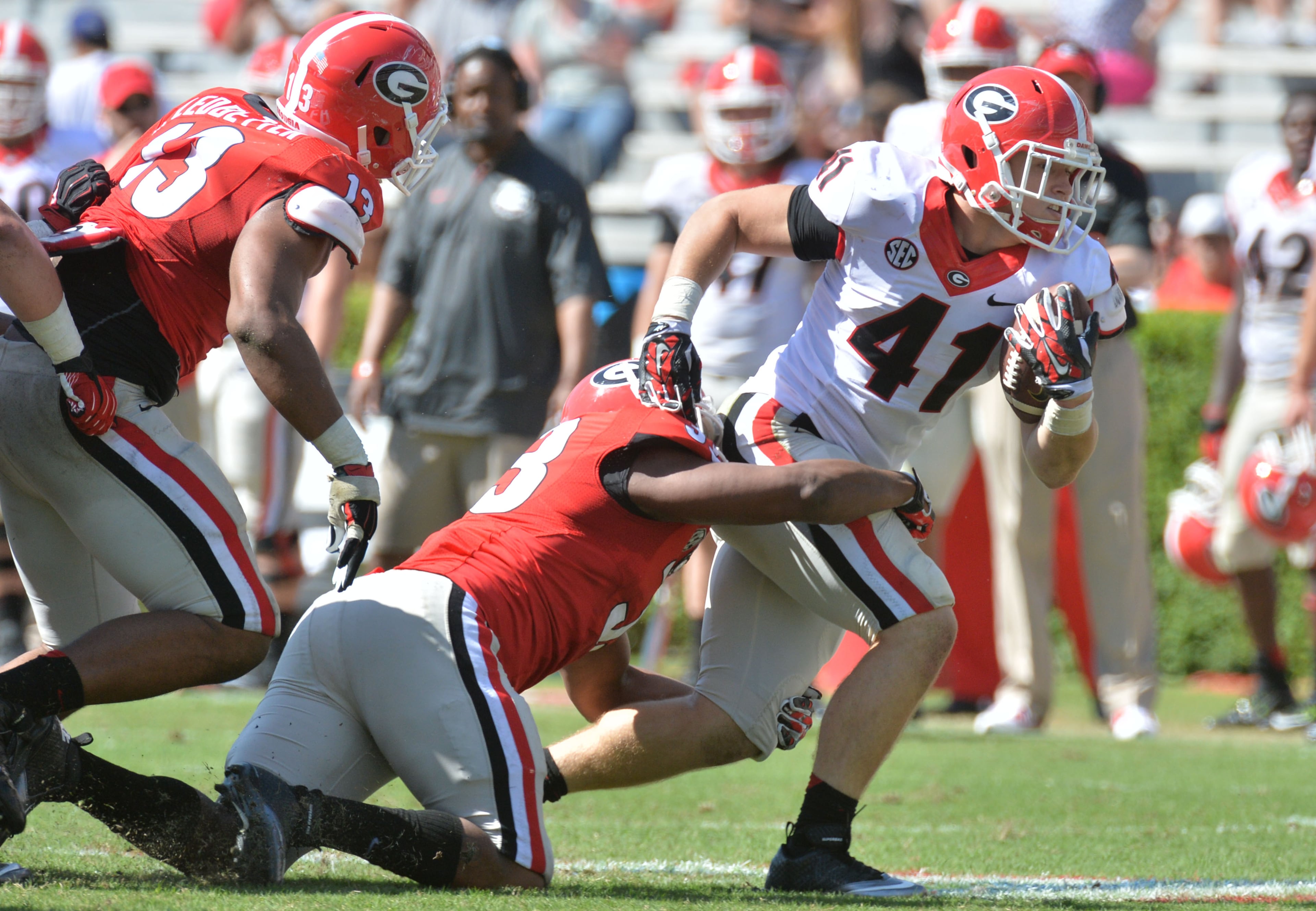 Georgia Bulldogs fullback Christian Payne (41) gets tackled by Georgia Bulldogs fullback Detric Bing-Dukes (33) in the second half of the 2015 Georgia Bulldogs G-Day game at Sanford Stadium in Athens on Saturday, April 11, 2015. HYOSUB SHIN / HSHIN@AJC.COM