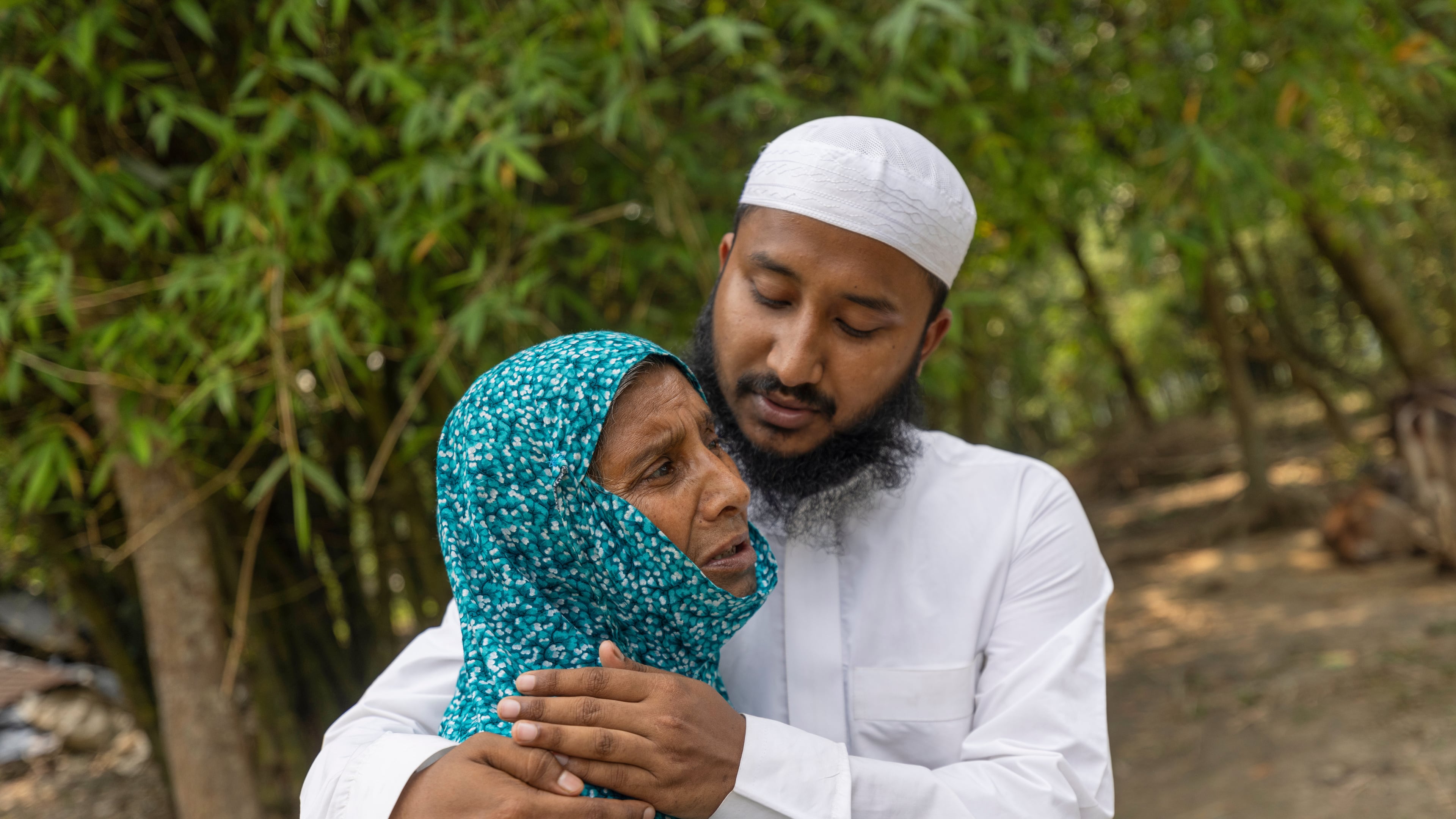 Maruf Hasan, brother of Mohammad Abdullah Al Mamun comforts his mother, Shahida Khatun, as she weeps at their home in Rasulpur village in Mymensingh district, Bangladesh, Friday, April 17, 2026. (AP Photo/Rajib Dhar)