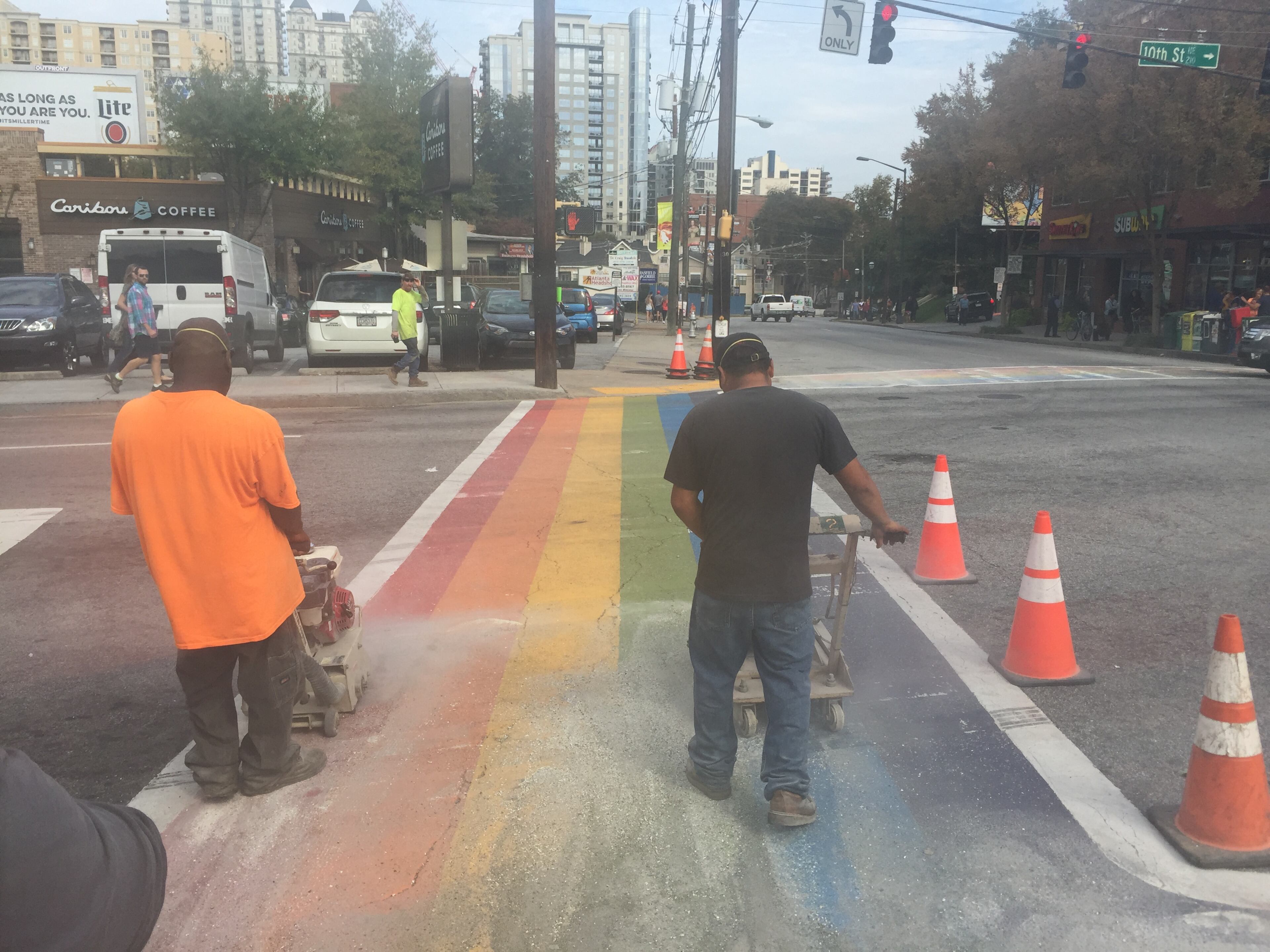 Construction crews at the intersection of 10th and Piedmont in Midtown erase the four rainbow crosswalks installed for Atlanta Pride on Saturday, October 24, 2015.