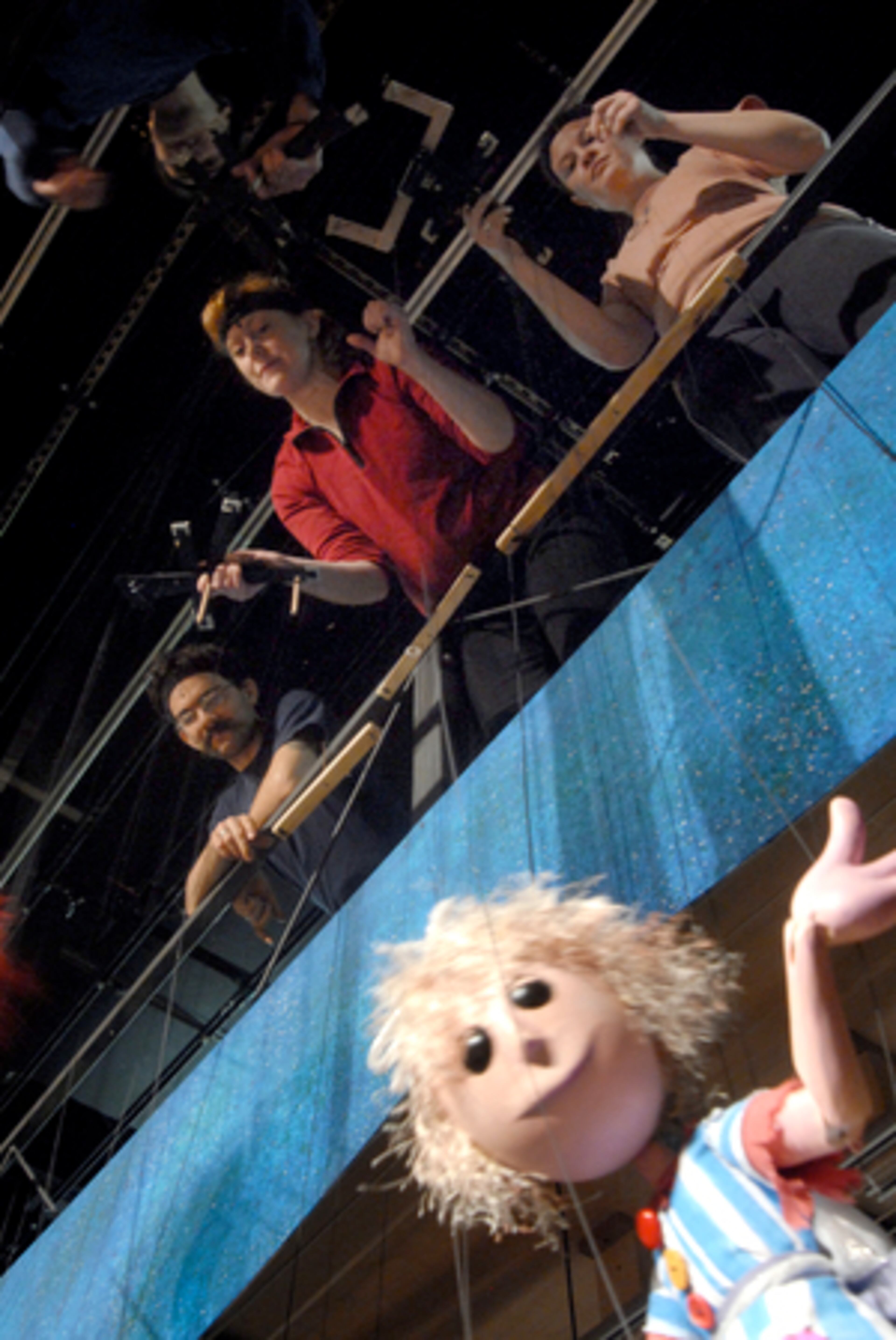 FOUR PUPPETEERS work the marionettes, which have 11 to 12 strings each. Balancing the Cinderella marionette on an 8-foot tightrope is especially precise for puppeteers such as (clockwise from top left corner) Julie Scarborough, Amy Strickland, Reay Kaplan and Michael Heverty.