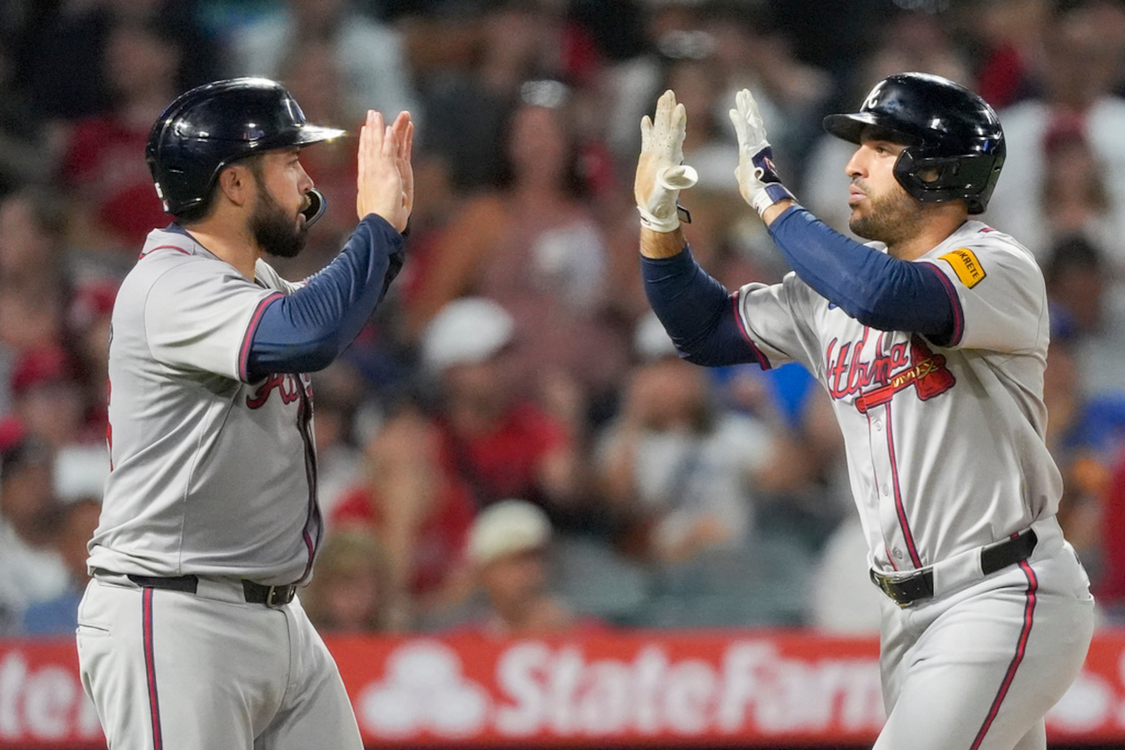 Atlanta Braves' Ramon Laureano, right, celebrates his two-run home run with Travis d'Arnaud, who also scored, during the fifth inning of a baseball game against the Los Angeles Angels, Saturday, Aug. 17, 2024, in Anaheim, Calif. (AP Photo/Ryan Sun)