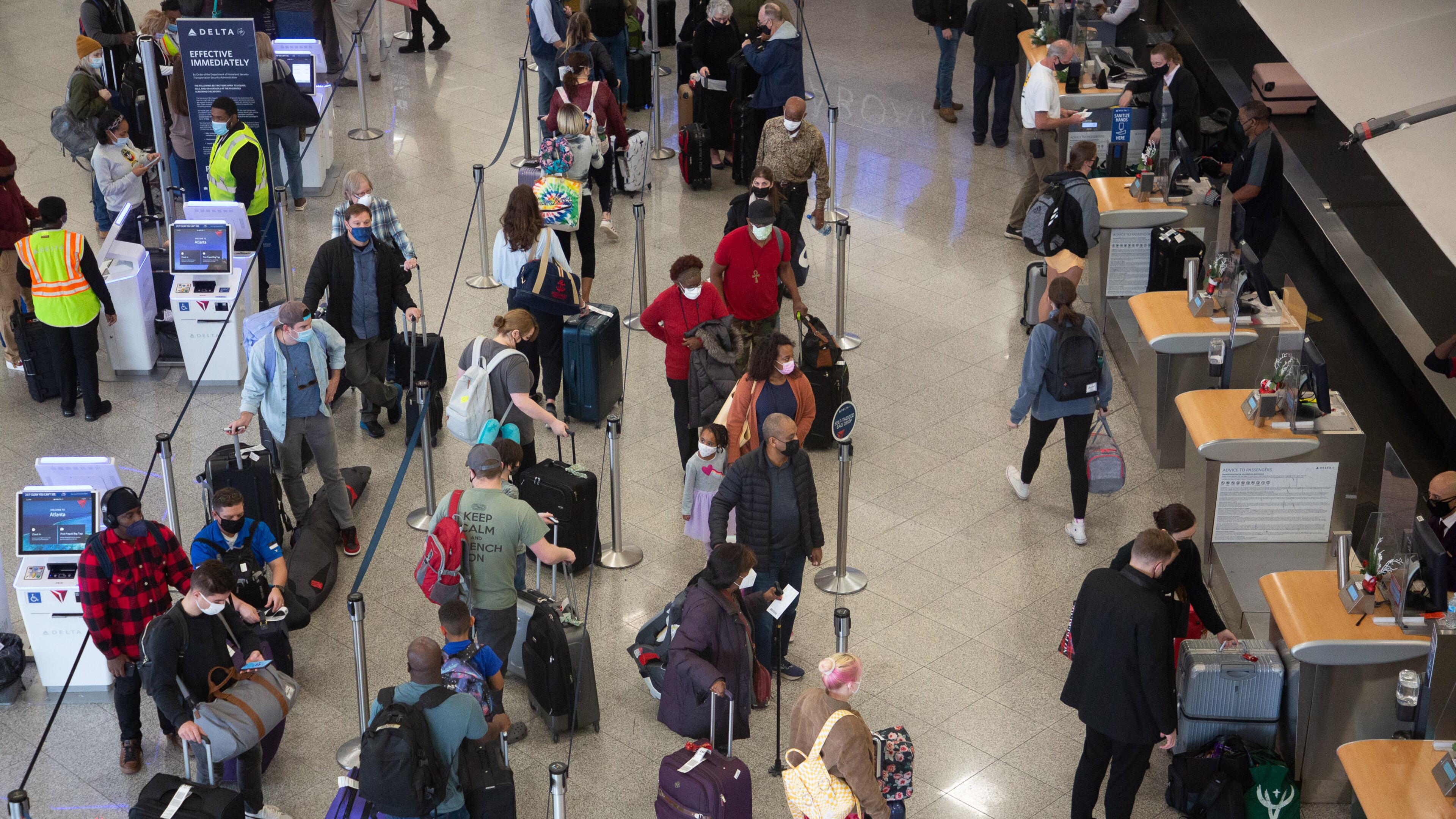 People wait in line at the Delta check-in at the South Terminal at the Hartsfield-Jackson International Airport December 27, 2021 STEVE SCHAEFER FOR THE ATLANTA JOURNAL-CONSTITUTION