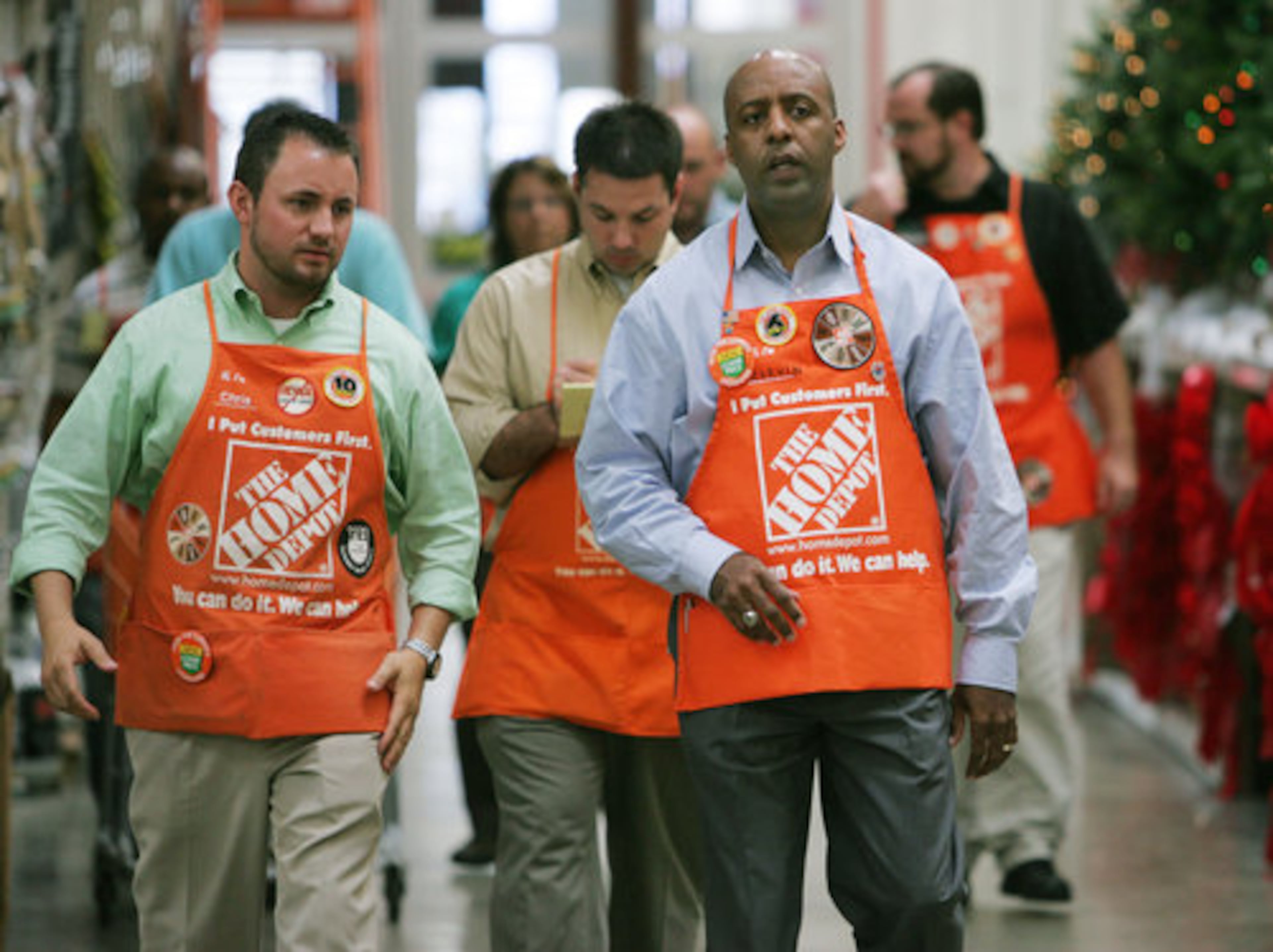 Marvin Ellison walks the Vinings store with District Manager Chris Wilson (left). Behind them is Store Manager Billy Mallon.