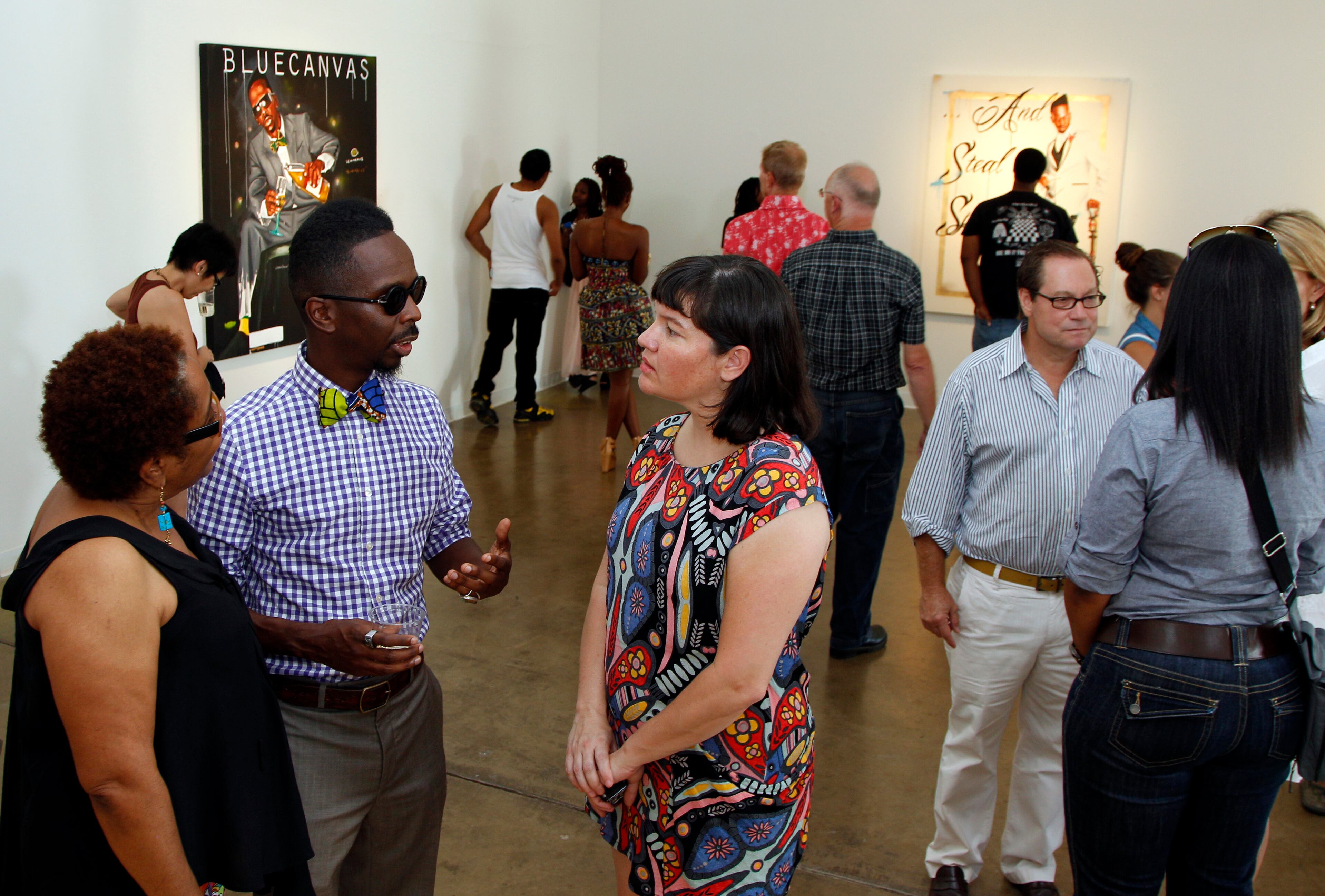 Pecou talks to Marion Marshall, left, and assistant director Danette Dufilho, right, during his show at the Conduit Gallery last month.