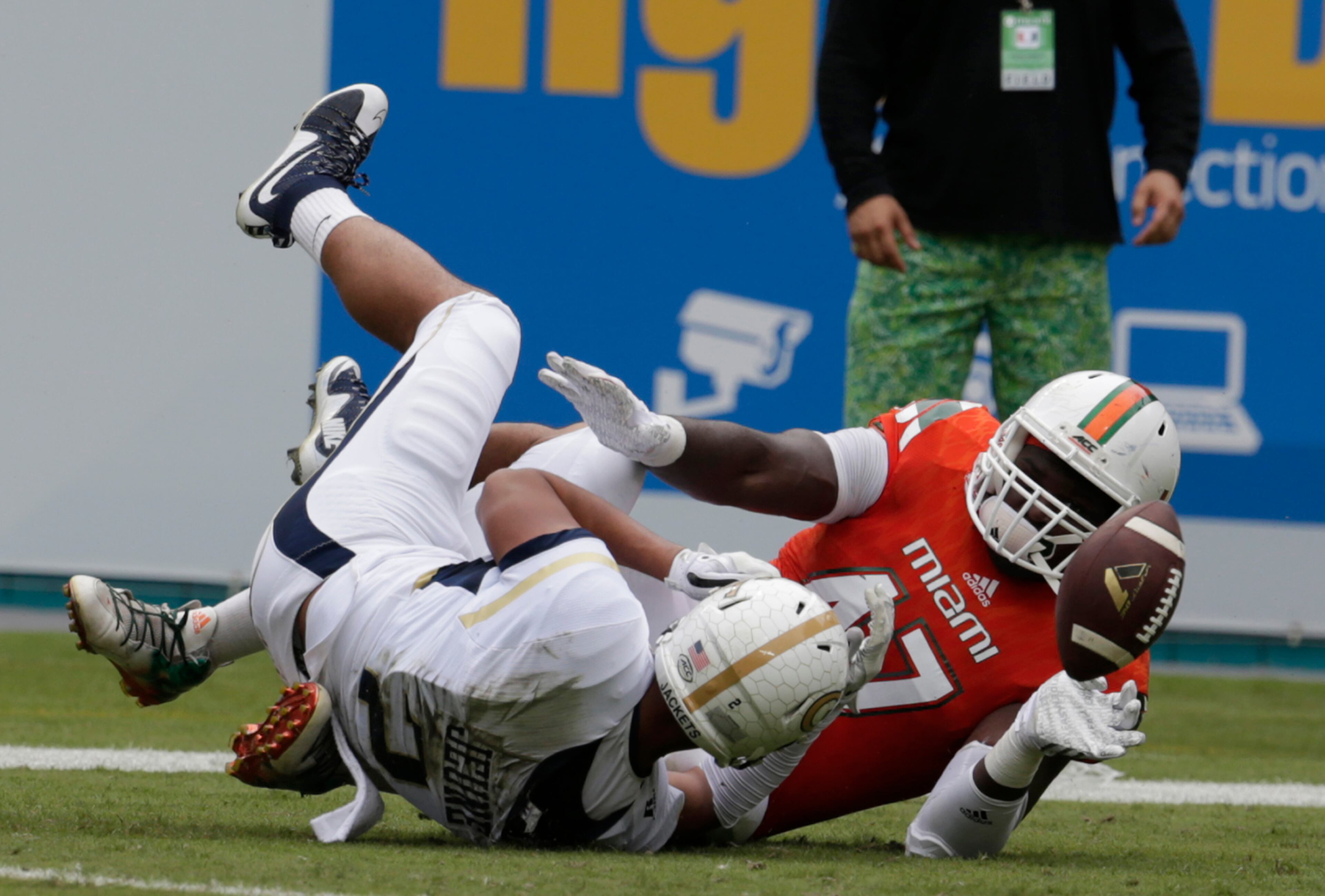 Miami defensive lineman Ufomba Kamalu (47) fumbles the ball he is brought down by Georgia Tech wide receiver Ricky Jeune after recovering a Georgia Tech fumble in the first half of an NCAA college football game, Saturday, Nov. 21, 2015 in Miami Gardens, Fla. Miami's Jermaine Jones recovered the ball for a touchdown. (AP Photo/Lynne Sladky)