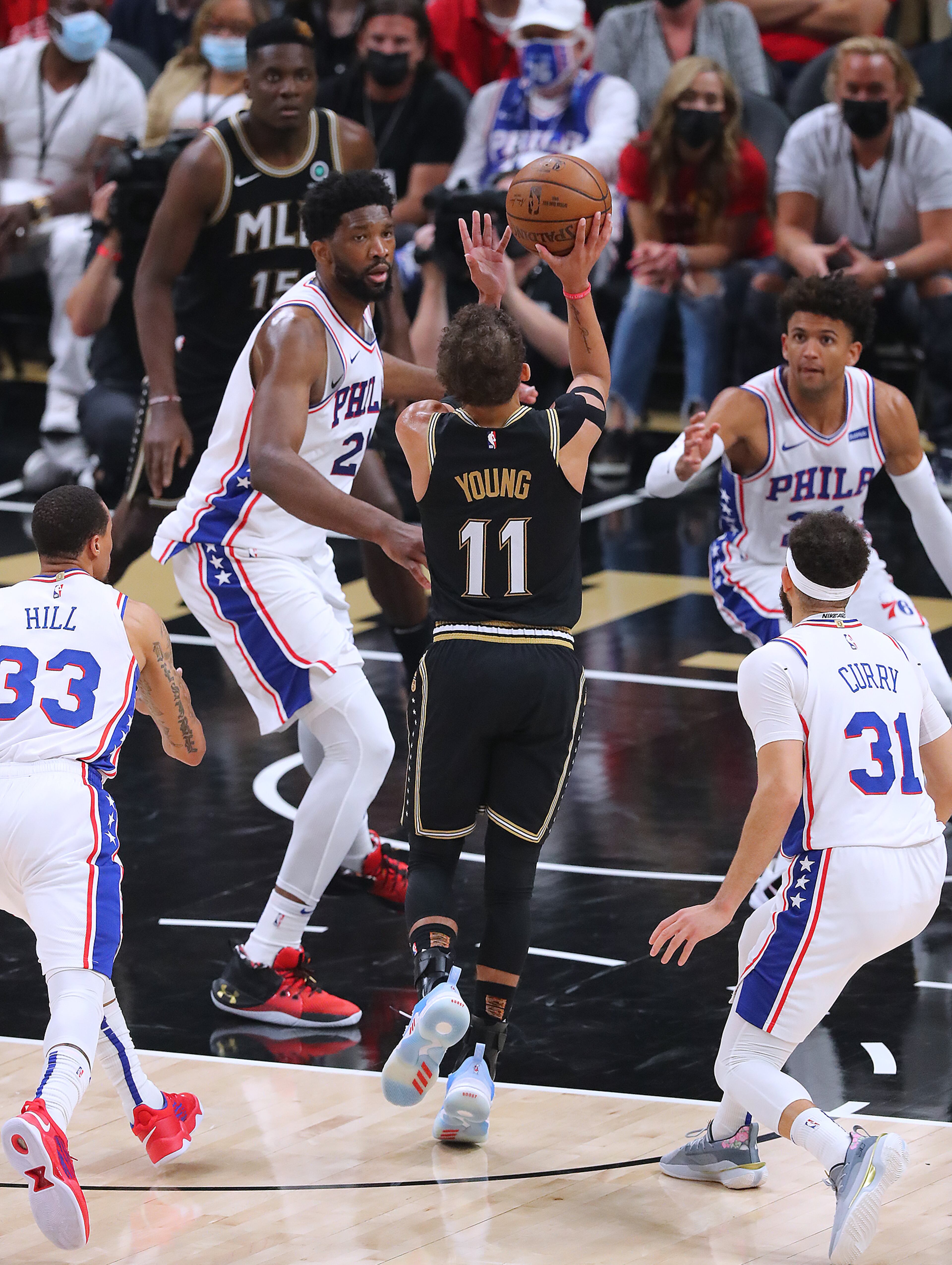 Hawks guard Trae Young shoots for two through Philadelphia 76ers defenders. “Curtis Compton / Curtis.Compton@ajc.com”