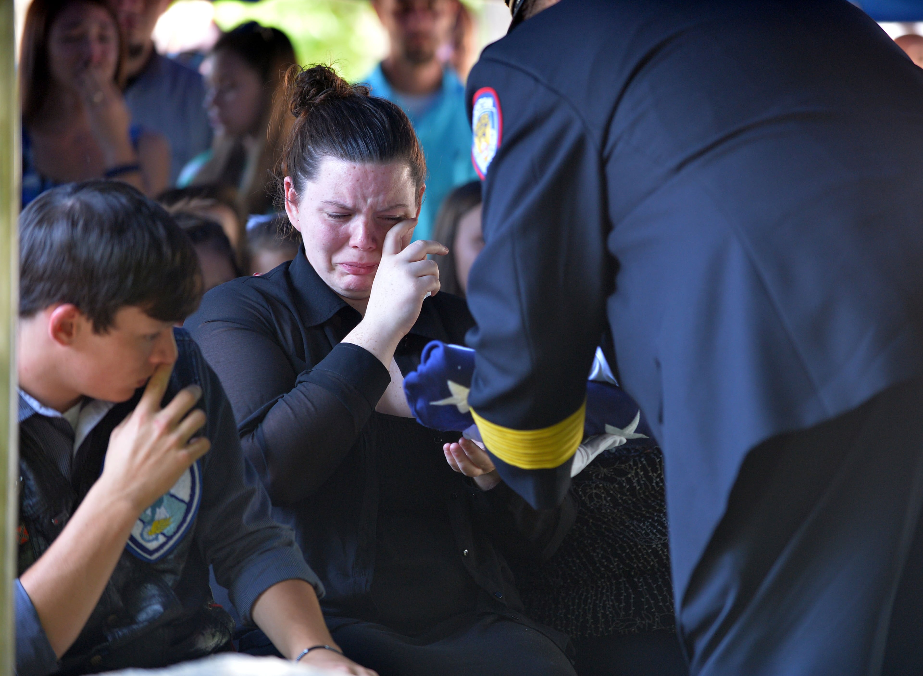 Officer Hawk's son and daughter Zachary and Victoria are presented the flag by Eatonton Police Chief Kent Lawrence. Officer Noel Lee Hawk served EPD for 12 years.