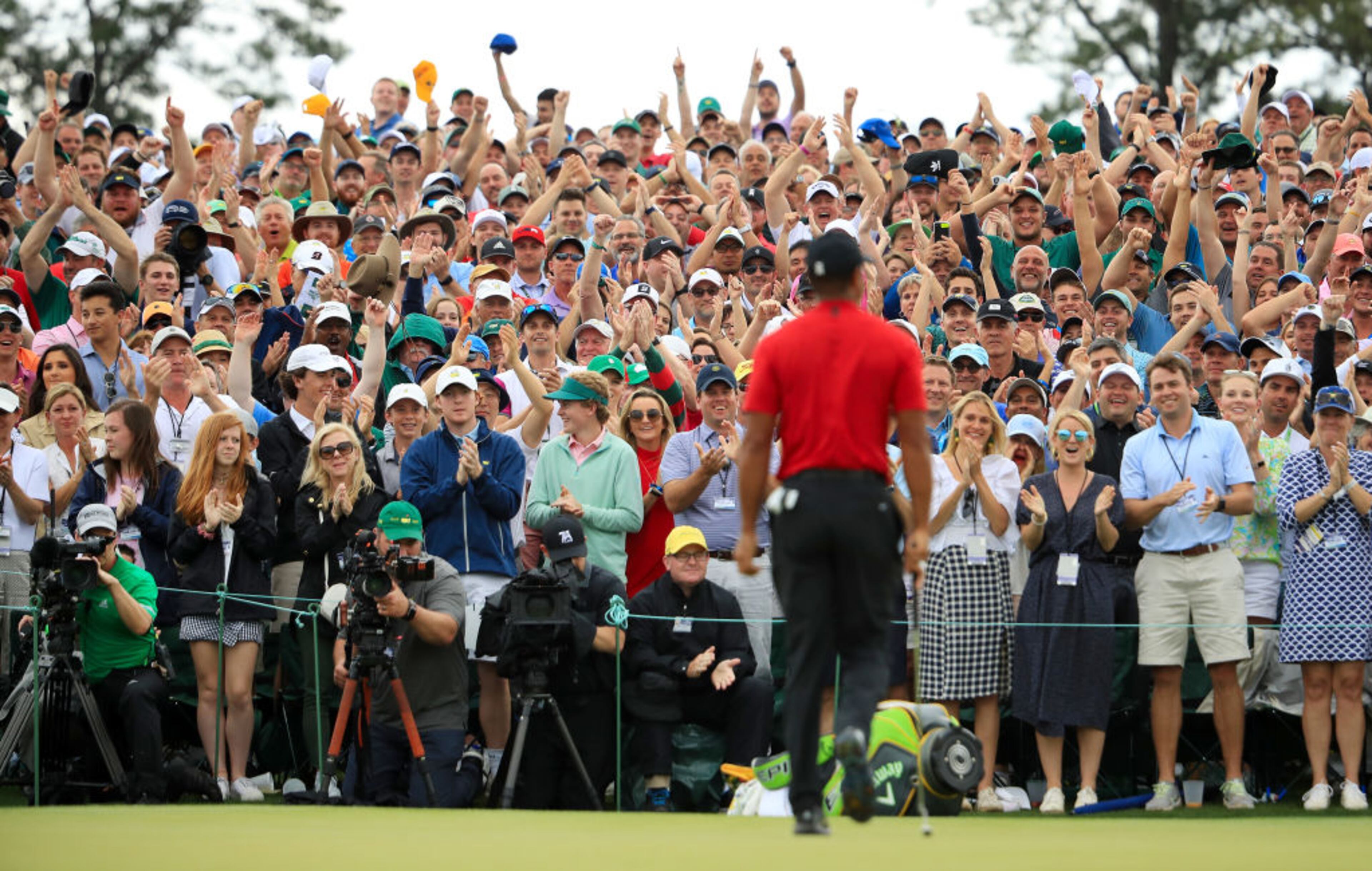 AUGUSTA, GEORGIA - APRIL 14: Patrons cheer as Tiger Woods of the United States walks off the 18th green after winning the final round of the Masters at Augusta National Golf Club on April 14, 2019 in Augusta, Georgia. (Photo by Andrew Redington/Getty Images)