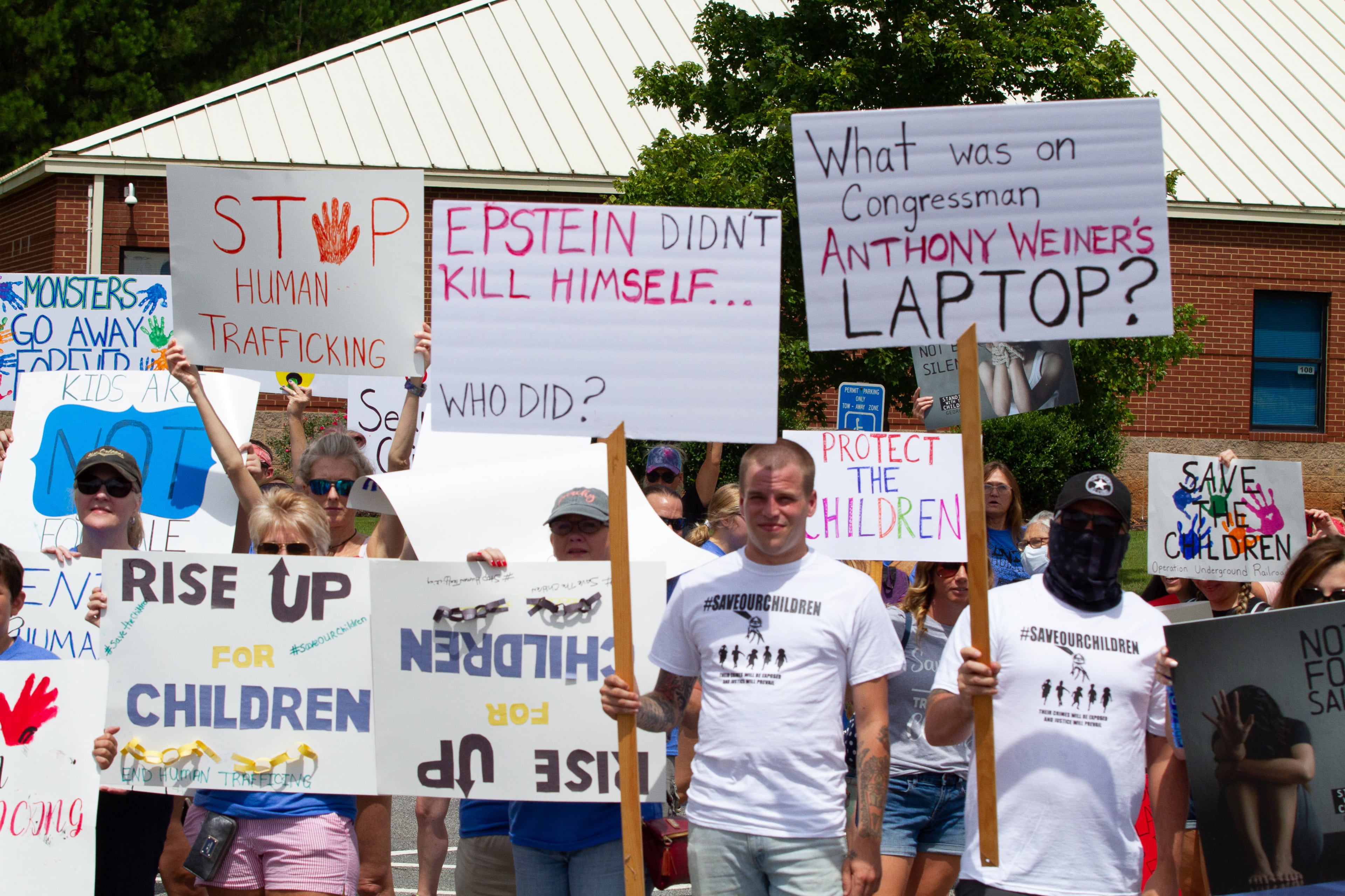 Standing with the Children protesters assemble at Woodstock Elementary before heading to the Elm Street Event Green in Woodstock Saturday, August 22, 2020. STEVE SCHAEFER FOR THE ATLANTA JOURNAL-CONSTITUTION